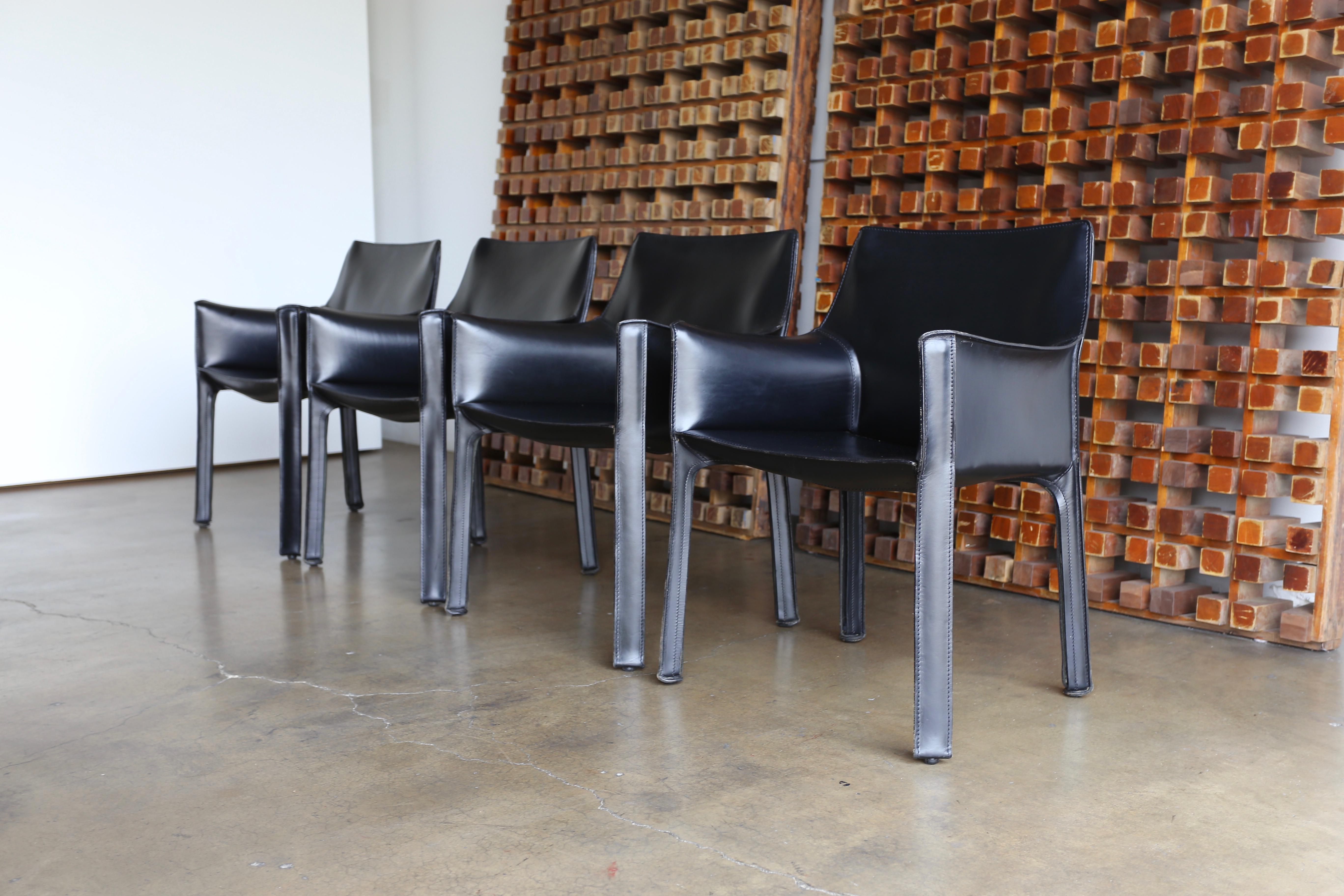 Set of four black leather cab armchairs by Mario Bellini for Cassina.