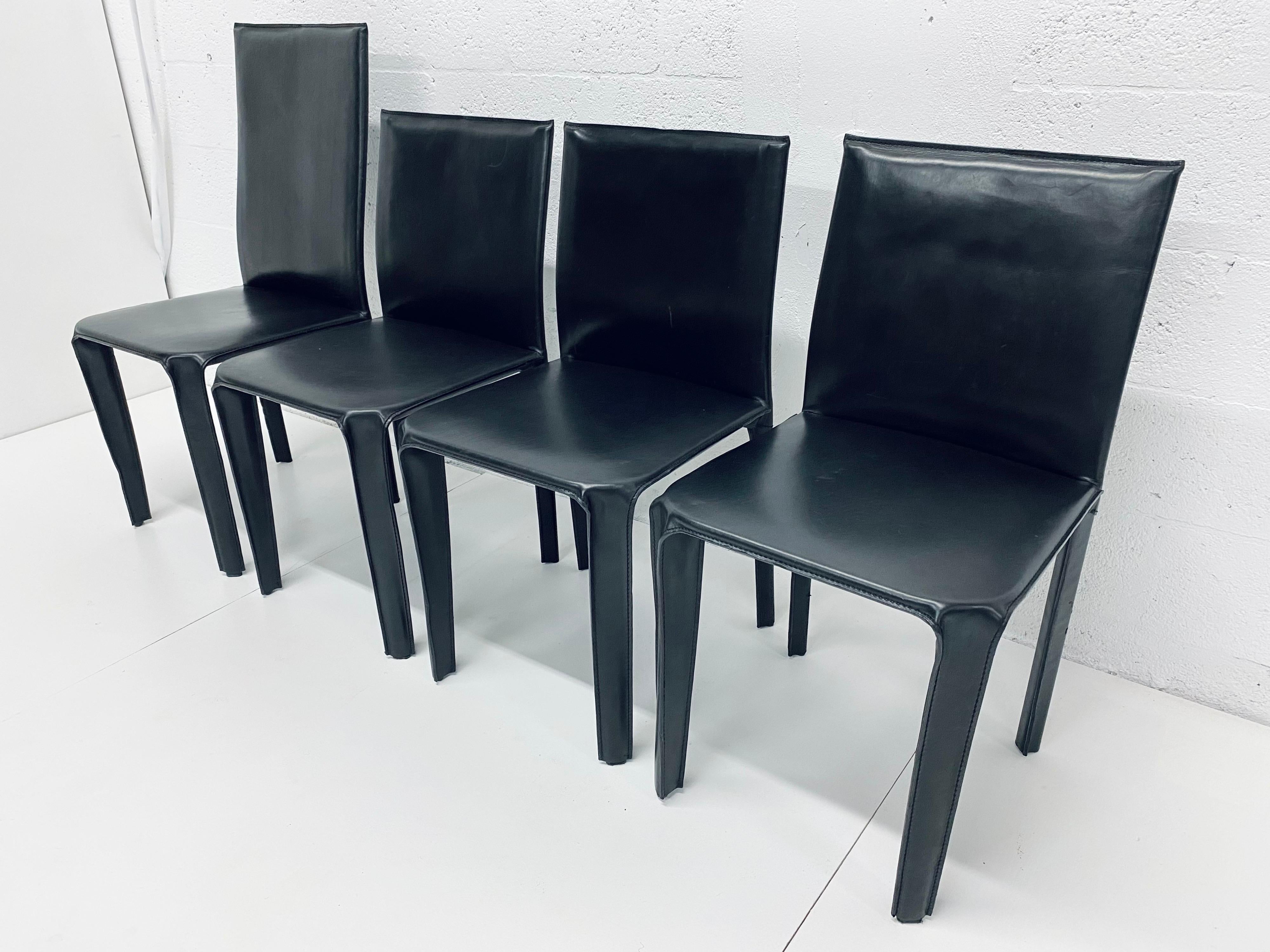 Set of four Italian black leather dining chairs by Arper. Each chair is stamped 