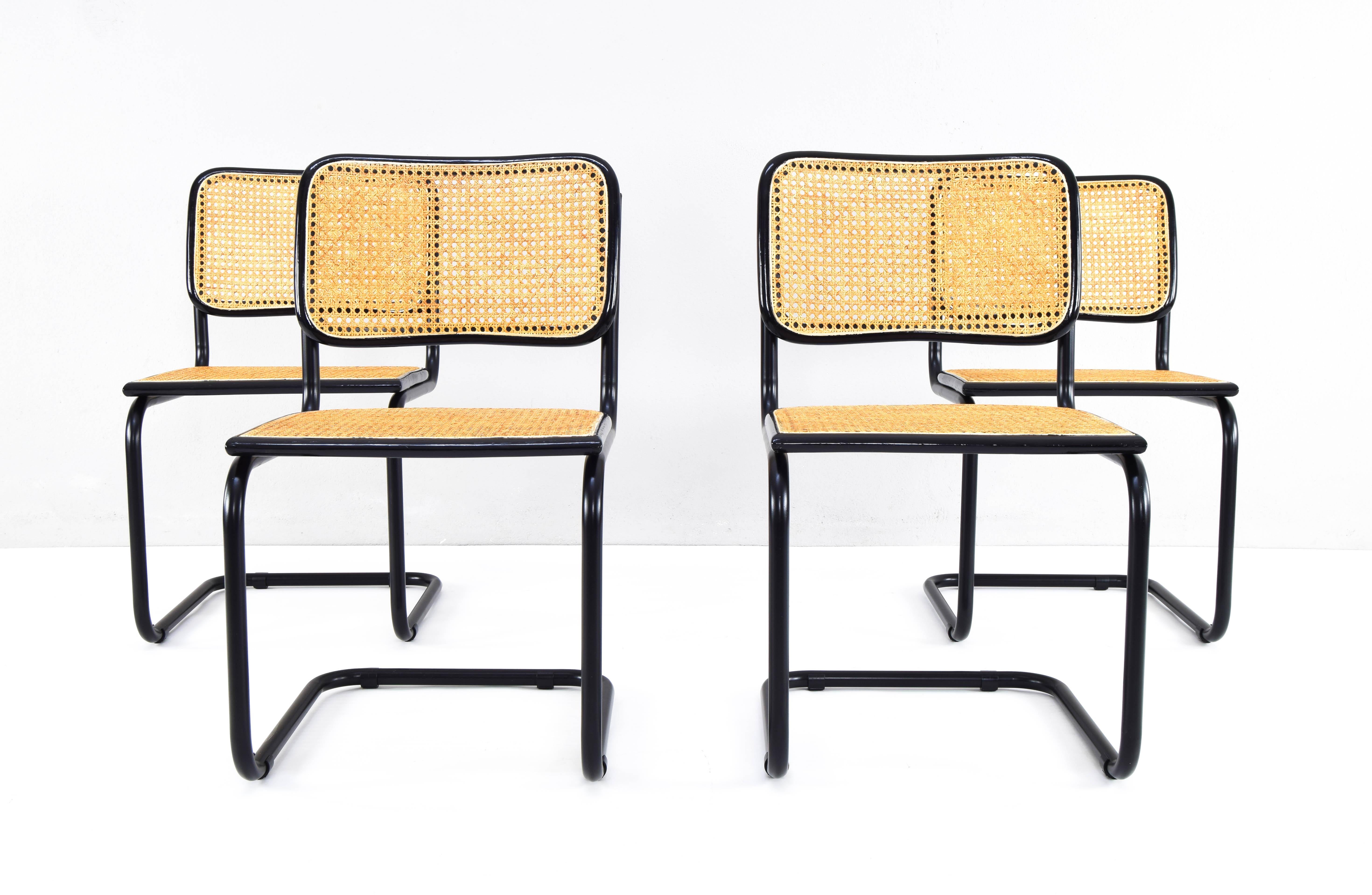 Set of four Cesca chairs, model B32, manufactured in Italy in the 1970s.
Black lacquered tubular structure, beech wood frames lacquered in black and Viennese natural grid.
The grilles on all four seats and the backs of chairs have been replaced