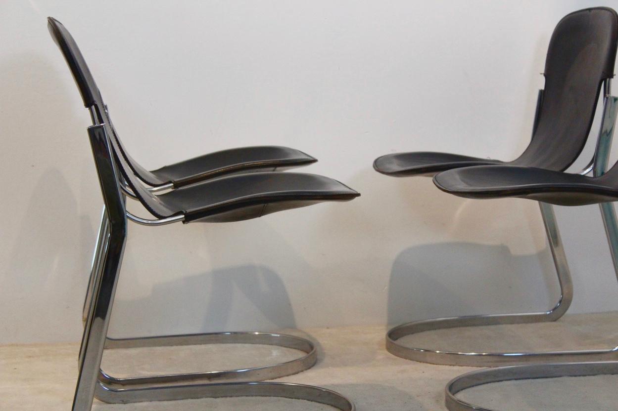 Superbly designed set of four ‘C2’ dining chairs in strong black Saddle Leather, designed by Willy Rizzo. The chairs are manufactured by the Italian company Cidue in the 1970s. They have a comfortable sit as the seats are nicely shaped to the human