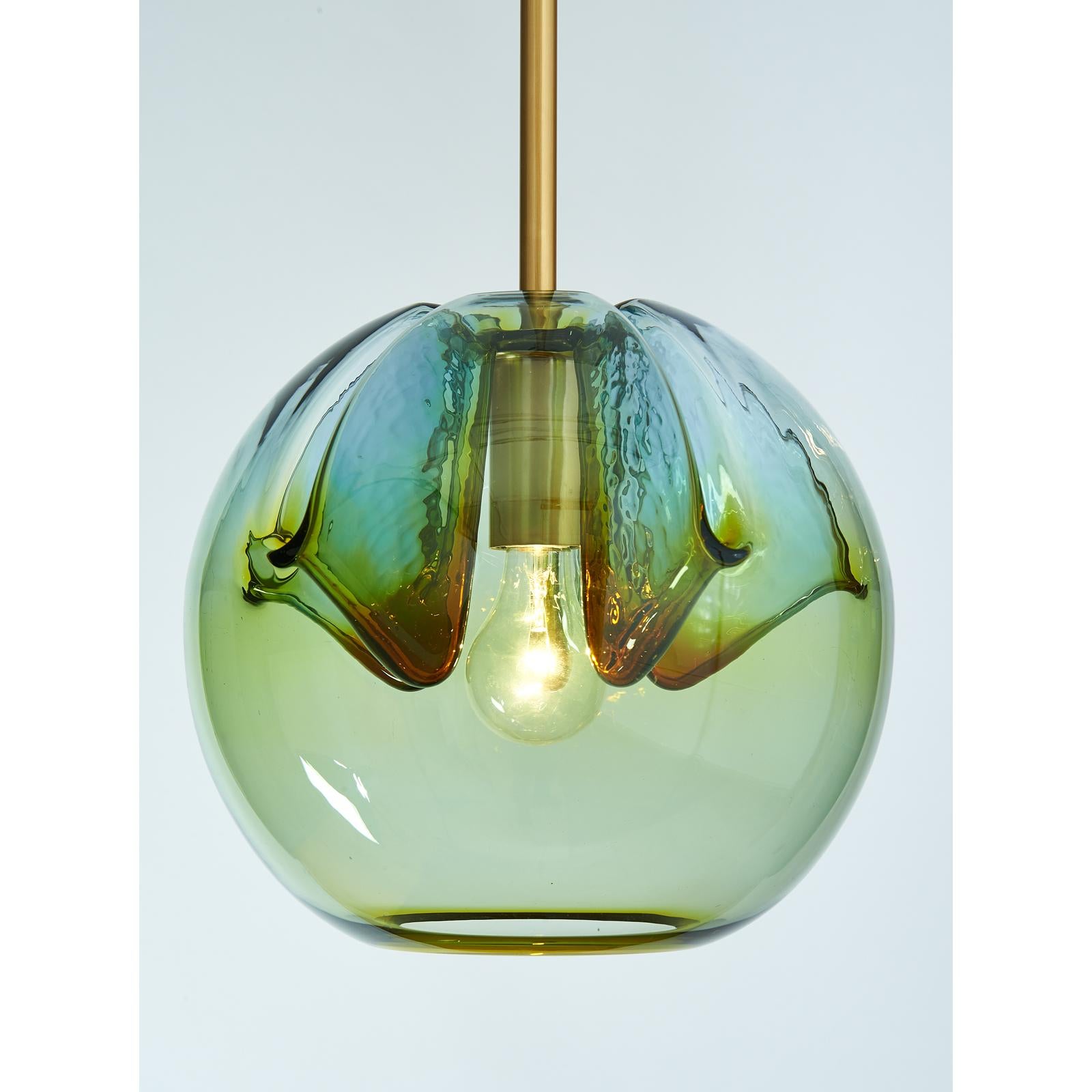 Italy, 1970s
Vintage blown colored glass globes, repurposed in our workshops as lanterns, with satin polished brass mounts. Artisanally mouth blown, the ensemble is unified but each globe has its own variation in hues. See last photo for variations.