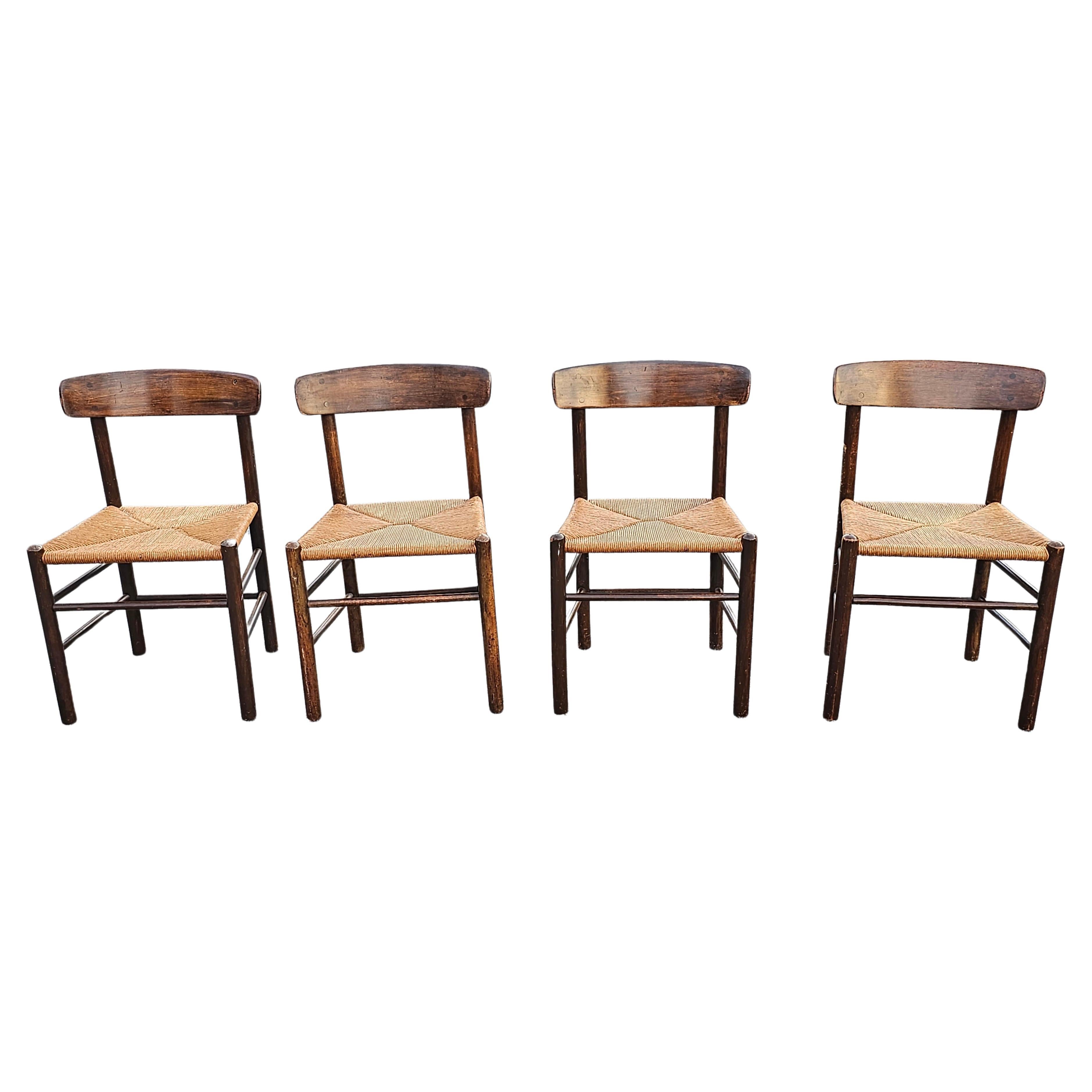 A set of Four Borge Mogensen J39 side chairs in Walnut and rush. Designed in 1947 by Borge Mogensen and Manufactured by FDB Mobler in 1960s. Measures 19