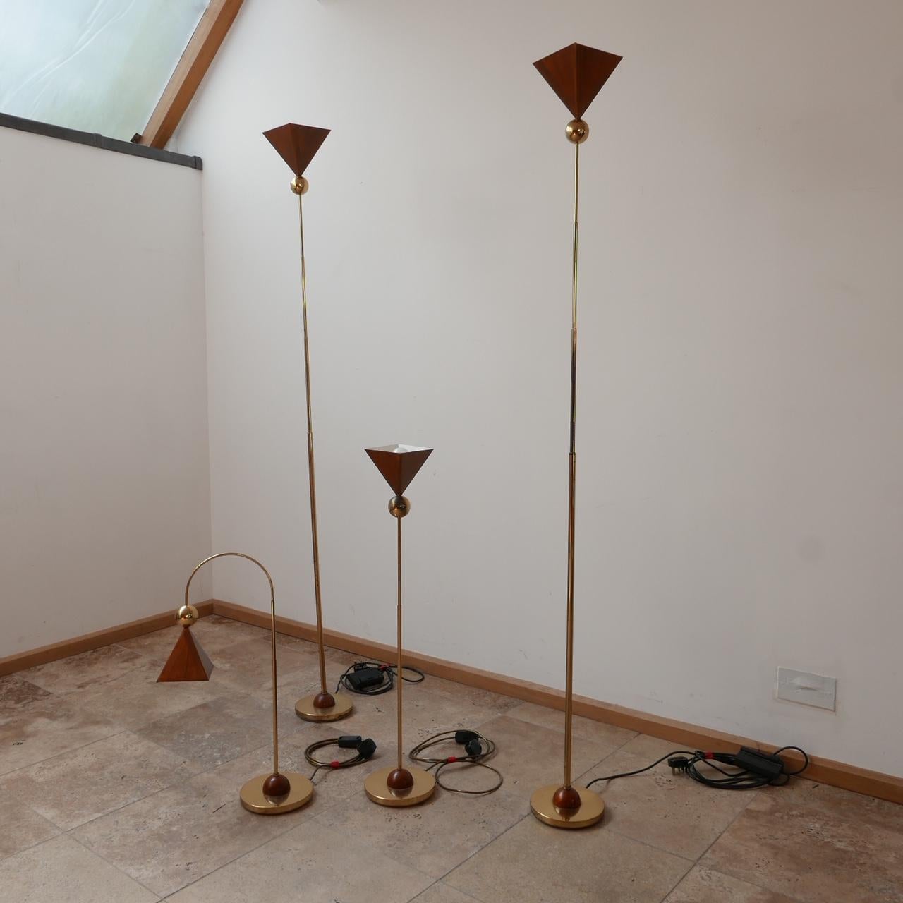 A set of four matching mid-century lights. 

Two tall floor lights, a straight table lamp, and a single curved table lamp. 

Brass and copper. 

Italy, c1980s. 

Price is for the set. 

Dimensions: floor lamps: 179 height x 19 diameter in