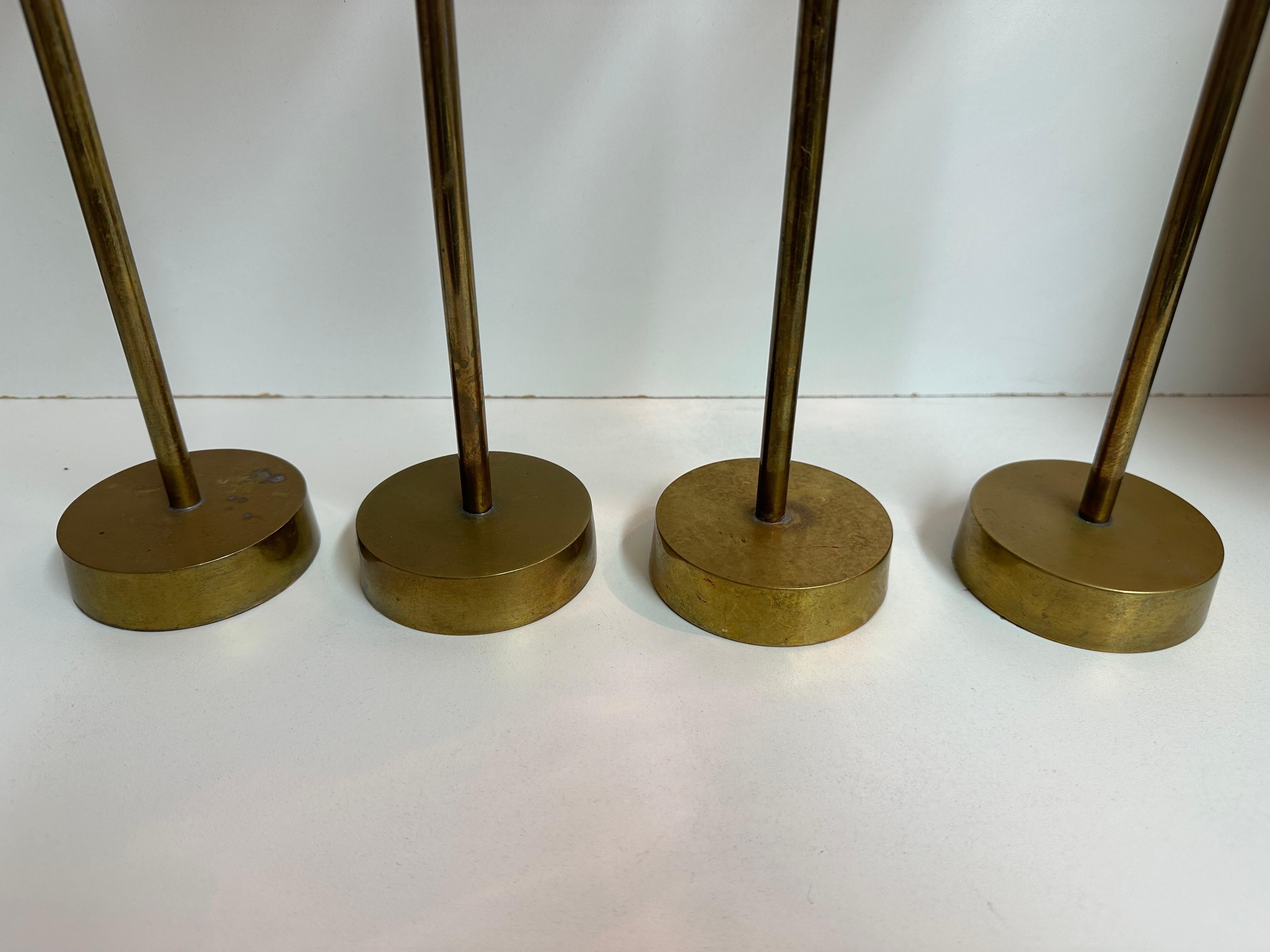 Set of four patinated brass candlesticks in the style of Pierre Forsell for Scultuna 