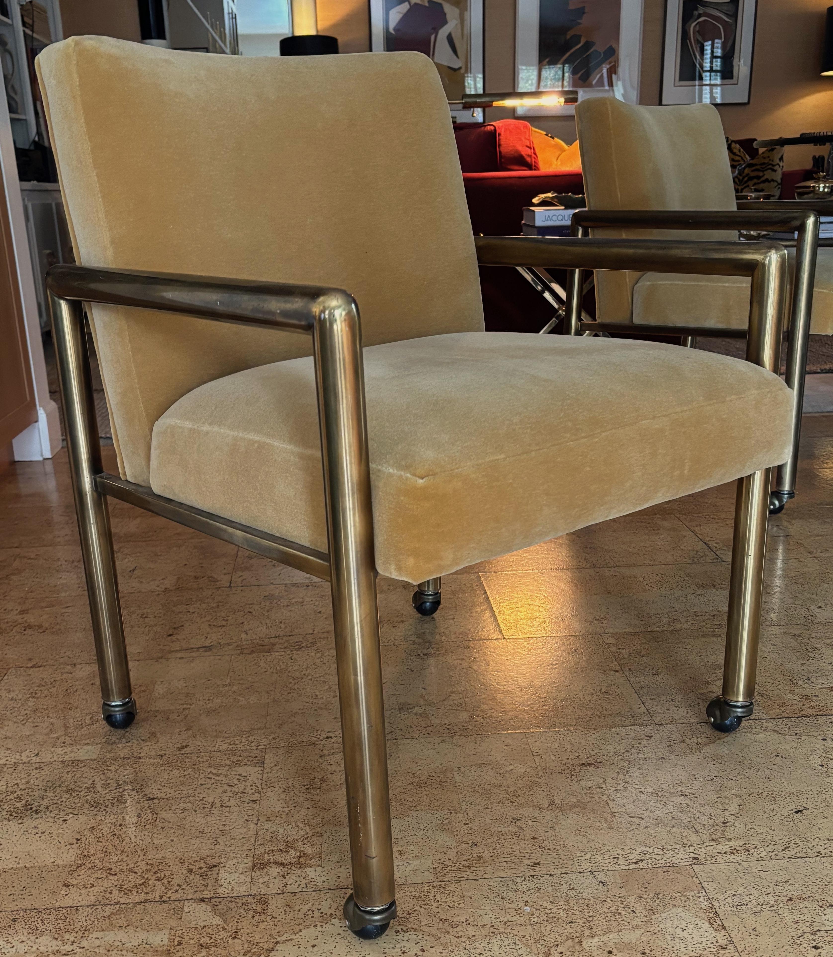 Set of Four Brass Club style Dining Chairs with Mohair upholstery by Mastercraft. The casters are new replacements as original. The set has been freshly upholstered in a luxurious Mohair velvet. Overall a stunning and super comfortable set of chairs