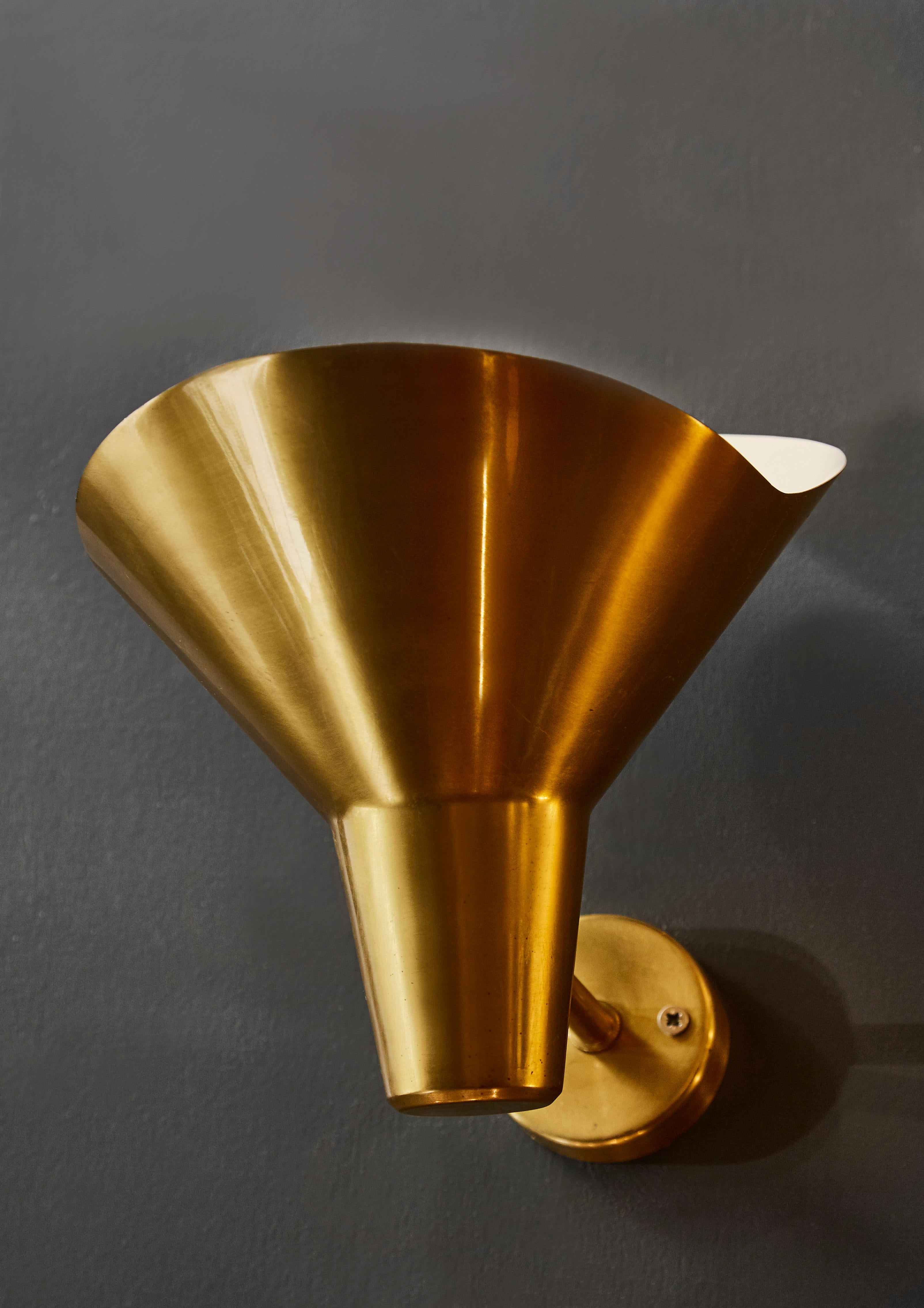 Set of four wall sconces made of a brass wide opened cone.