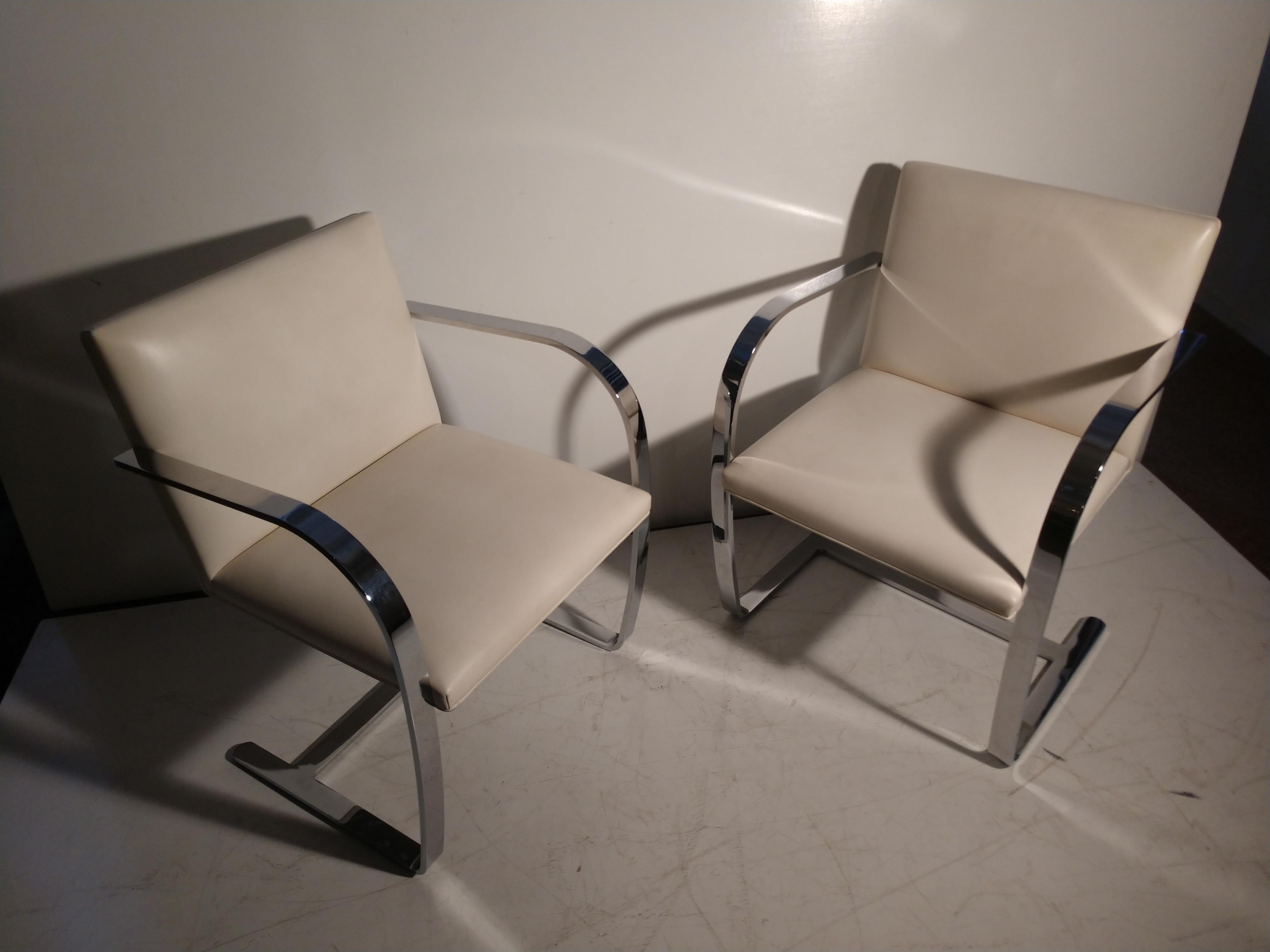 Fabulous set of 4 signed Knoll Brno lounge dining chairs by Mies Van Der Rohe in white leather. All original in excellent vintage condition with minimal wear to leather. Absolute no damage to stainless steel which is polished to a mirror finish. See
