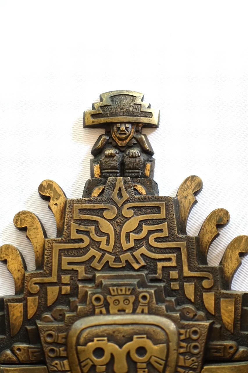 A set of four bronze midcentury Aztec-motif two-arm sconces. Sold per pair.

Measurements:
Height 11