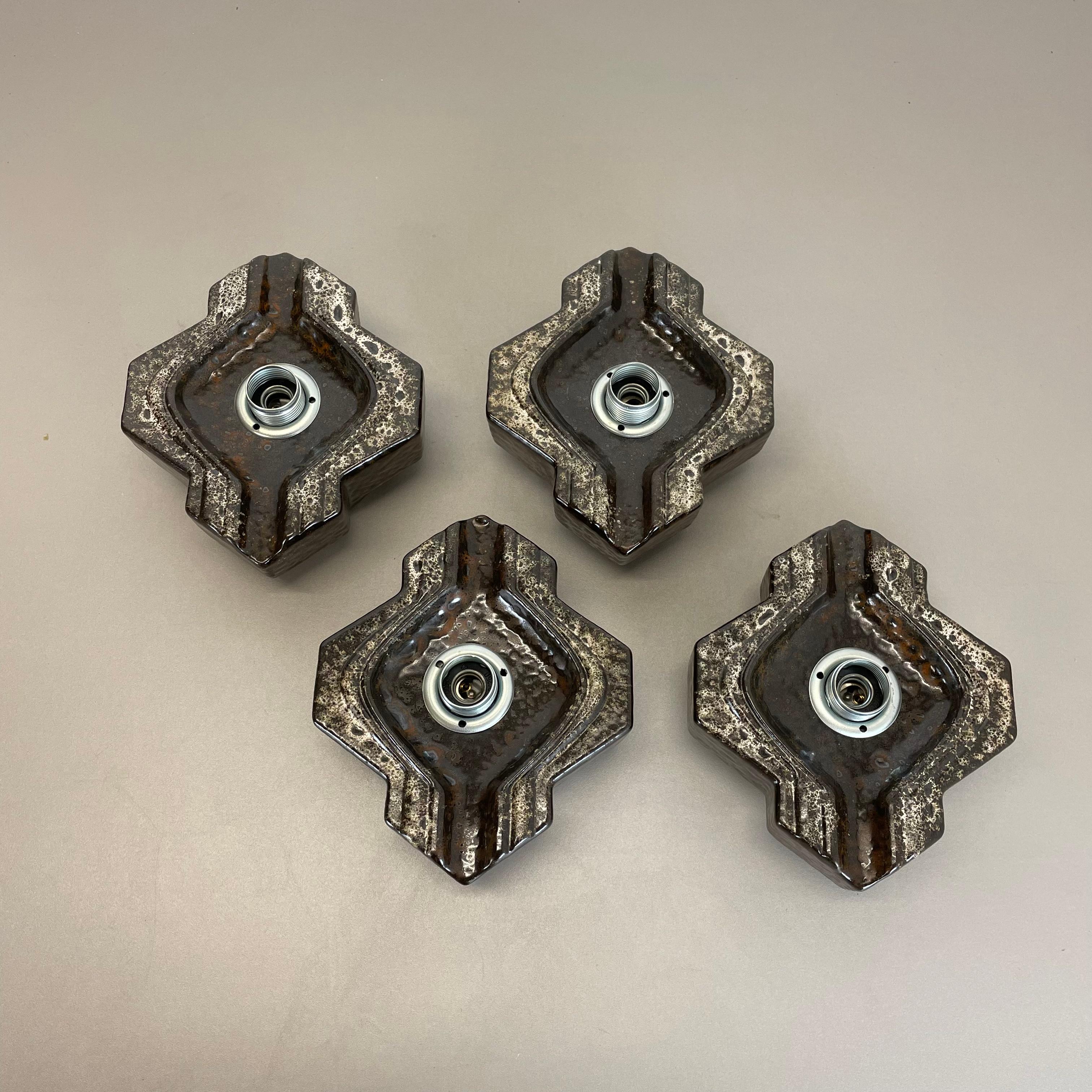 Article:

Wall light sconce set of four


Producer:

Pan Ceramic, Germany.



Origin:

Germany.



Age:

1970s.



Description:

Original 1970s modernist German wall light made of ceramic in fat lava optic. This super rare set of four walls light