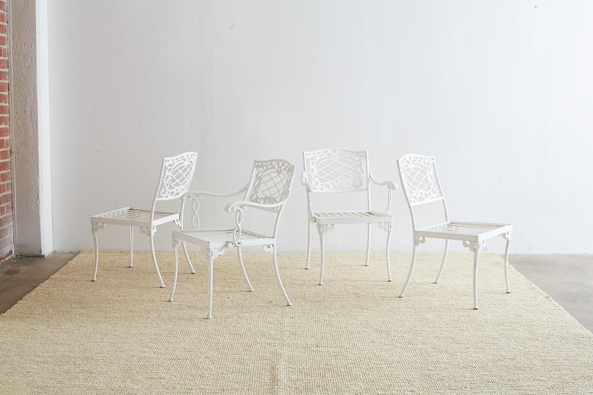 Stately set of four aluminium garden and patio chairs by Brown Jordan with a  neoclassical style pattern. Features a sand cast aluminium frame with a multi-step white powder coat finish. Consists of two armchairs and two side chairs the latter being