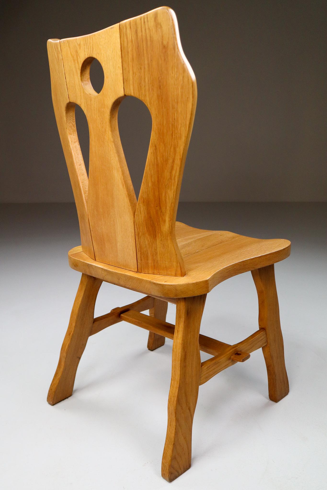 Set of four brutalist chairs in blond oak, Belgium, 1960s.

A set of four wooden dining chairs. These chairs are made of blond oak and sculpturally crafted by hand. The craftsmanship is still visible, they are made of solid oak wood and