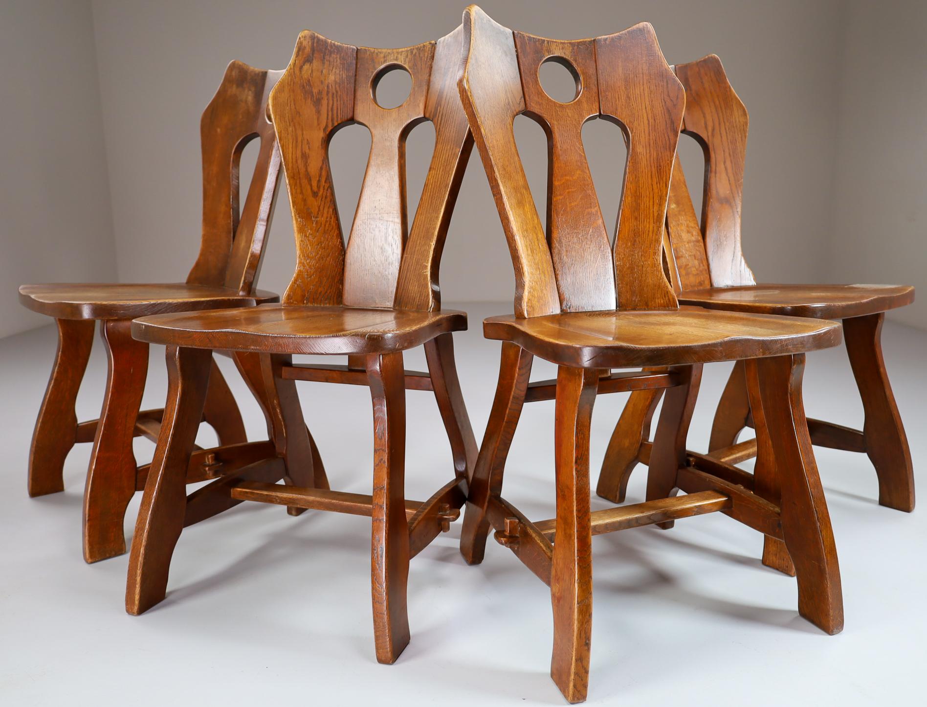 Set of four brutalist chairs in patinated oak, Belgium, 1960s.

A set of four wooden dining chairs. These chairs are made of oak and sculpturally crafted by hand. The craftsmanship is still visible, they are made of solid oak wood and constructed