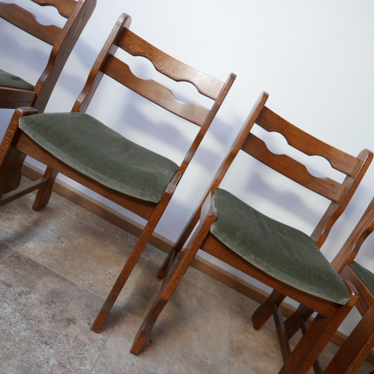 A set of four dining chairs, of Brutalist form.

Oak, circa 1970s, Belgium.

In perfect conditon it is just the upholstery that needs updating but they are perfectly usable in the interim.

Can be re-covered or re-upholstered in-house upon