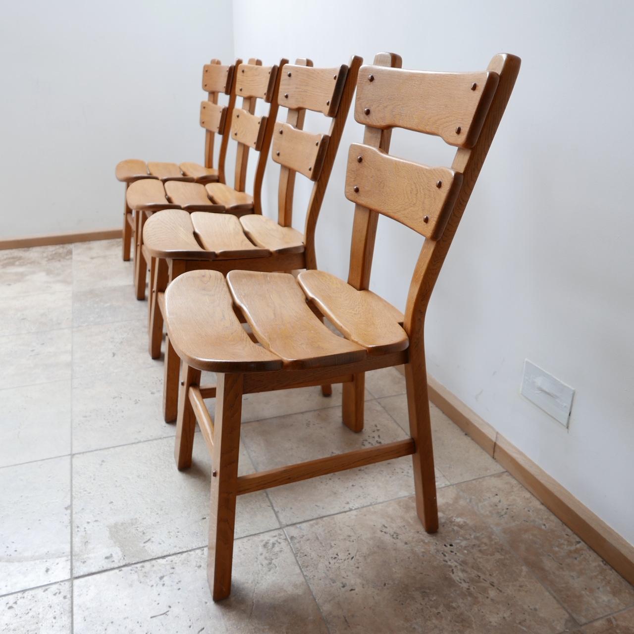 Set of four oak brutalist dining chairs. 

Belgium, c1970s. 

Price is for the set of four. 

Good condition and solid well made construction. 

Dimensions: 47 W x 50 D x 47 Seat Height x 90 Total Height in cm.

Delivery: POA.

 