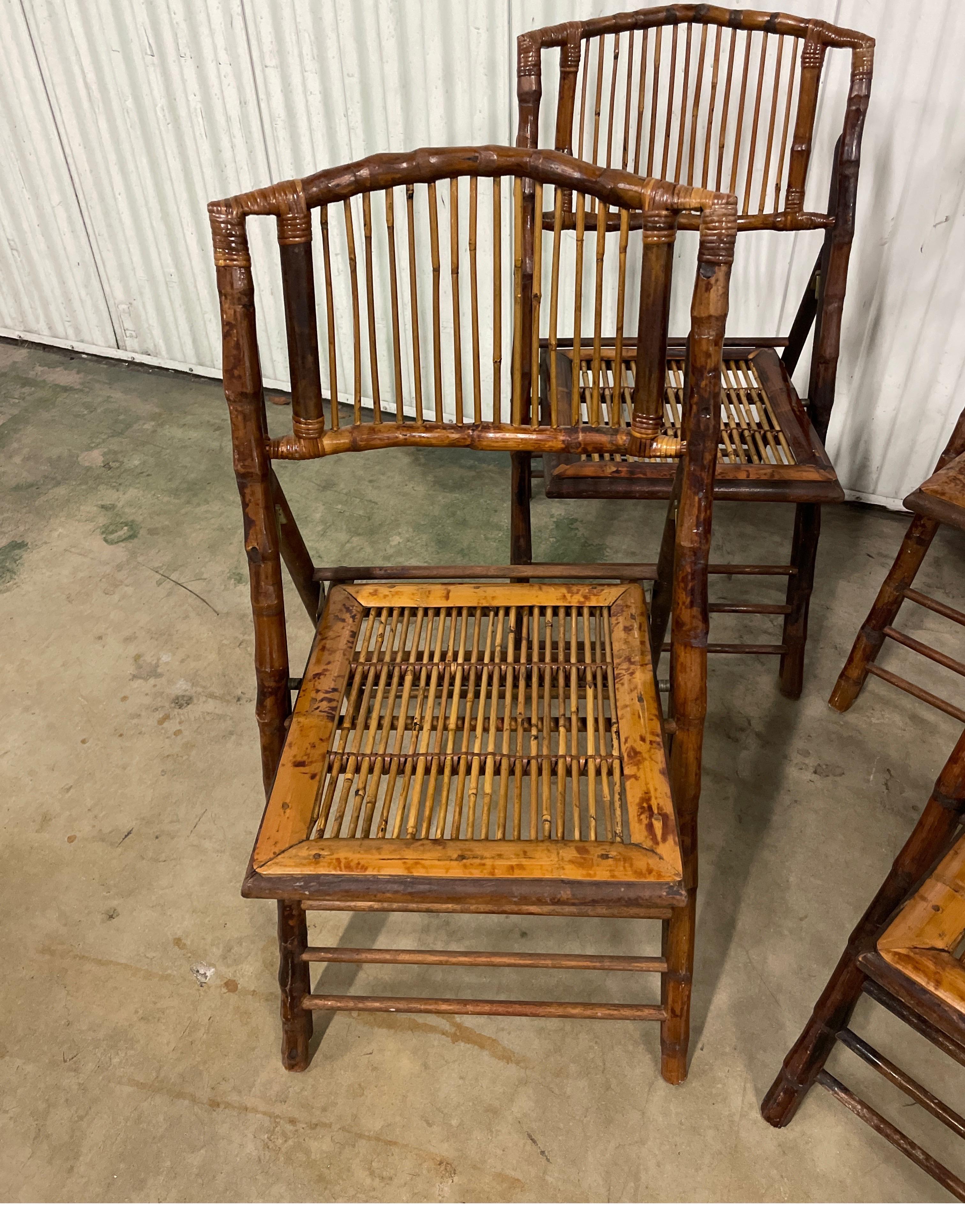 Very good set of four British Colonial Style Burnt Bamboo Tortoise folding chairs. Well constructed and sturdy. An additional set of four is also available for purchase.