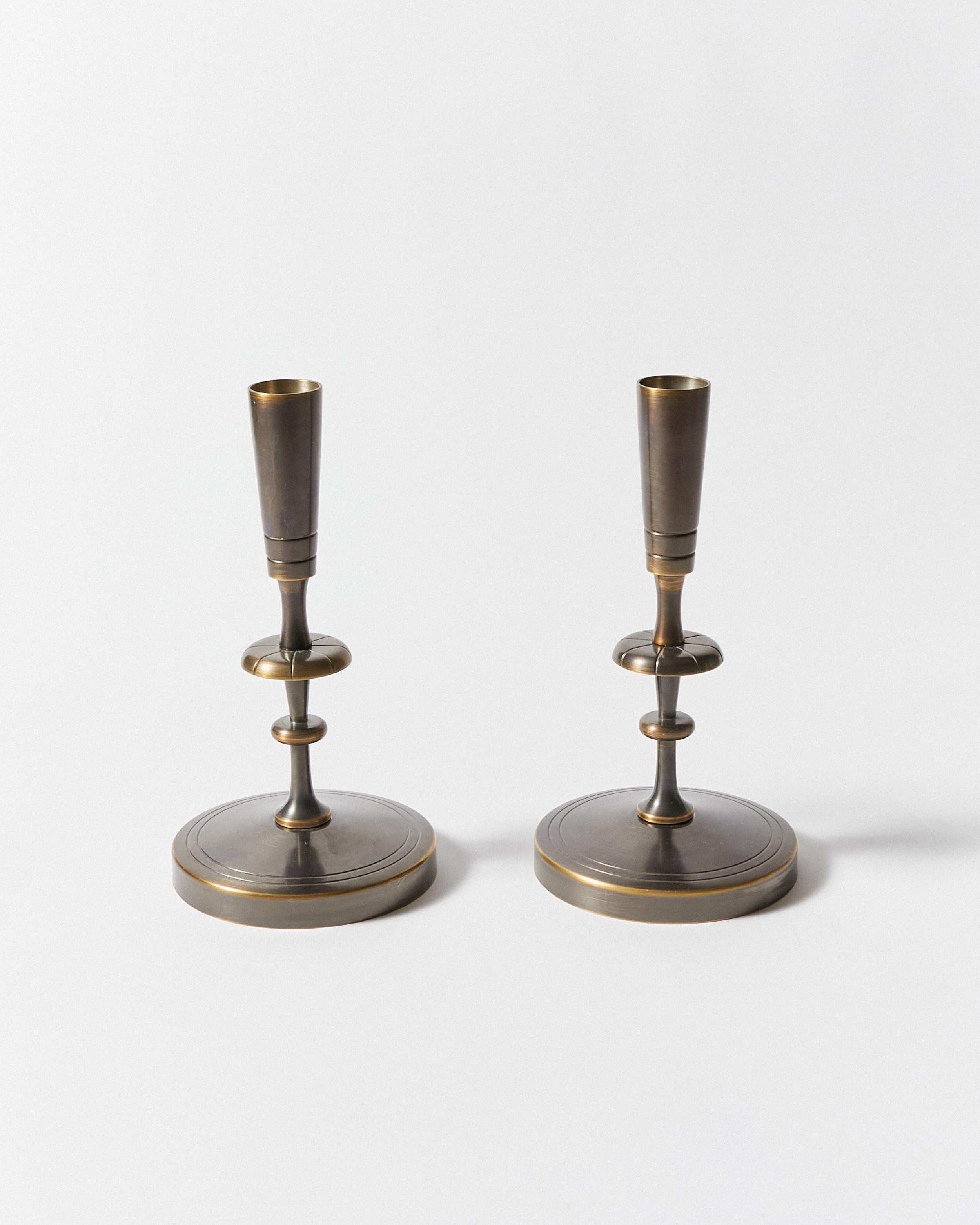 Set of four candlesticks re-finished in antique bronze. Designed by Tommi Parzinger for Dorlyn-Silversmiths.