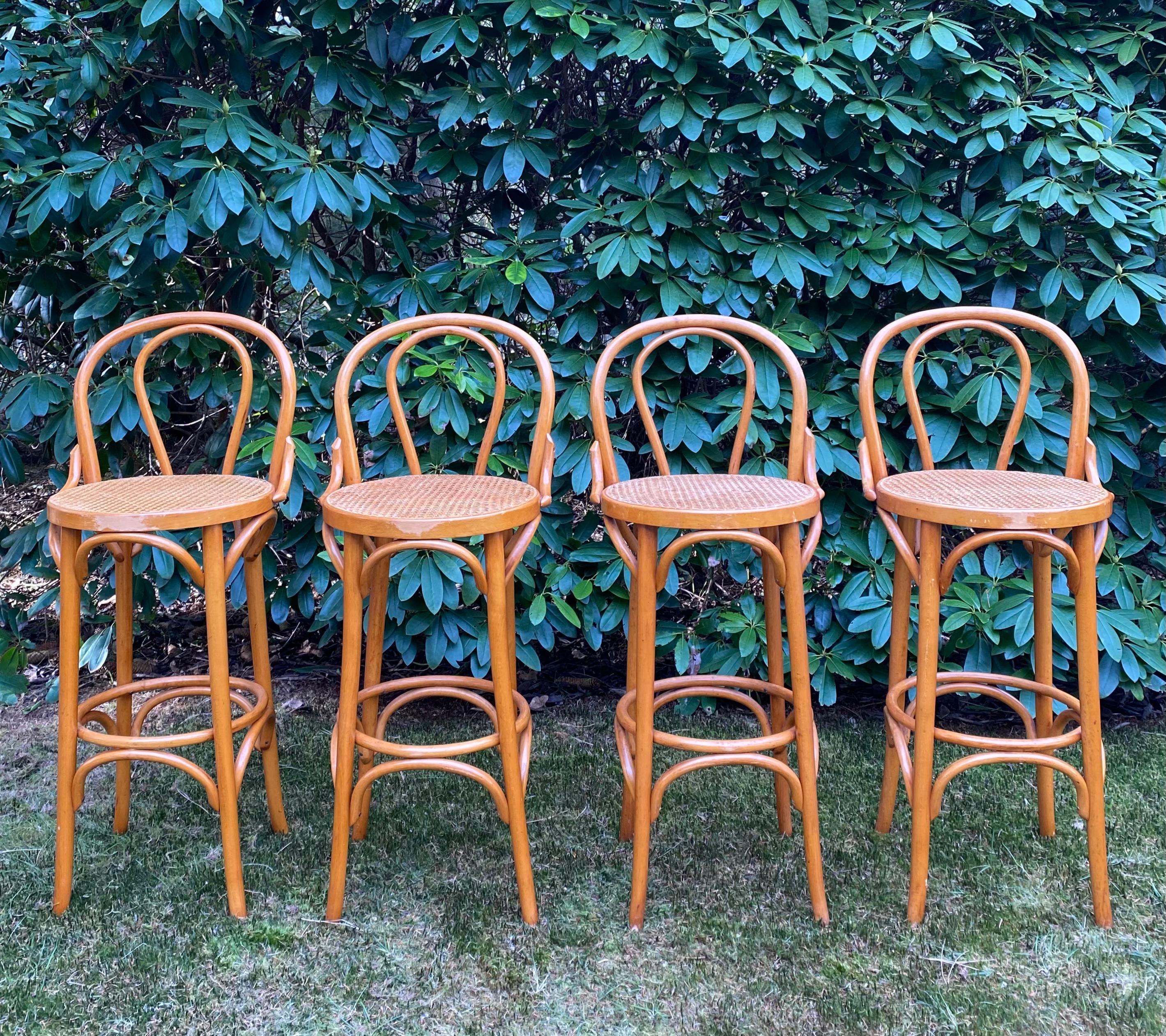 This set of four, Late 20th Century, Bar stools feature a Beech bentwood base with webbing seatings. The stools remain in good condition with some wear as shown on the images. They would fit very nicely in a Bohemian, Mid-Century or Romantic styled