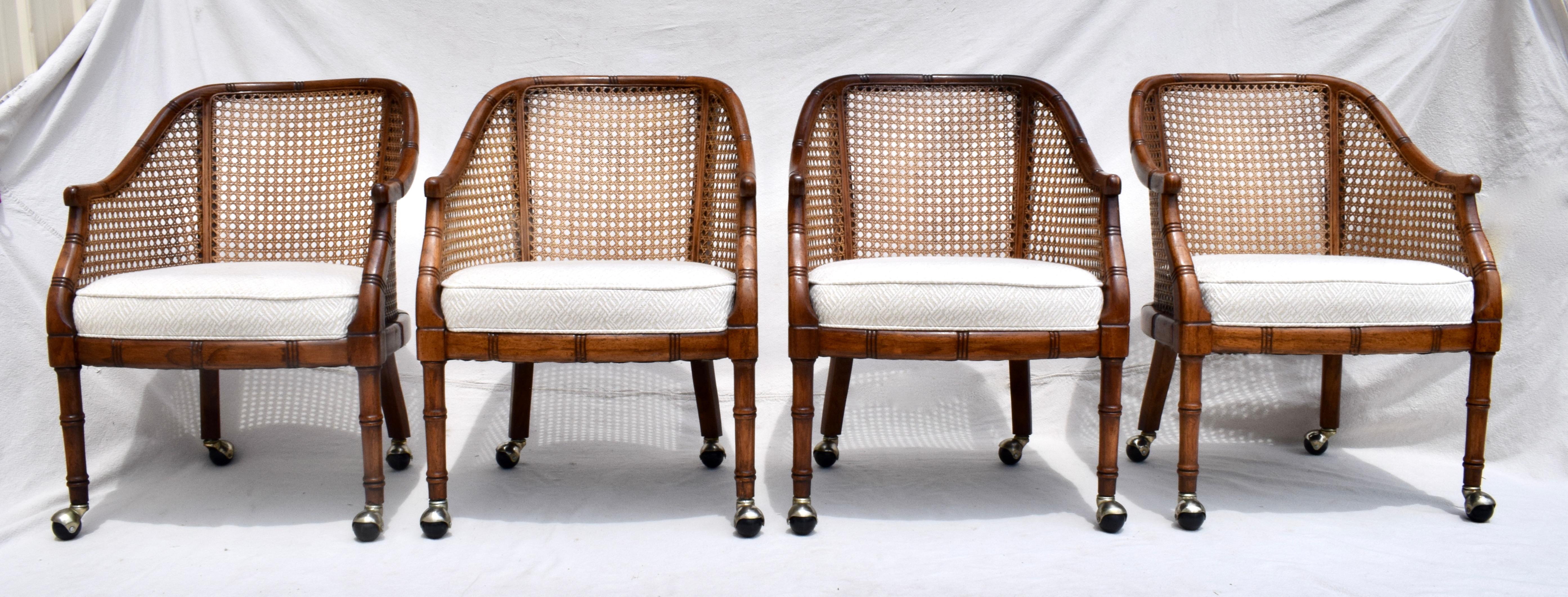 Exceptional set of four Mid-Century Modern barrel chairs in the manner of Harvey Probber featuring faux-bamboo wooden frames on casters with caned backs and sides. The stationary seats are custom upholstered in hand loomed & textured cotton tapestry