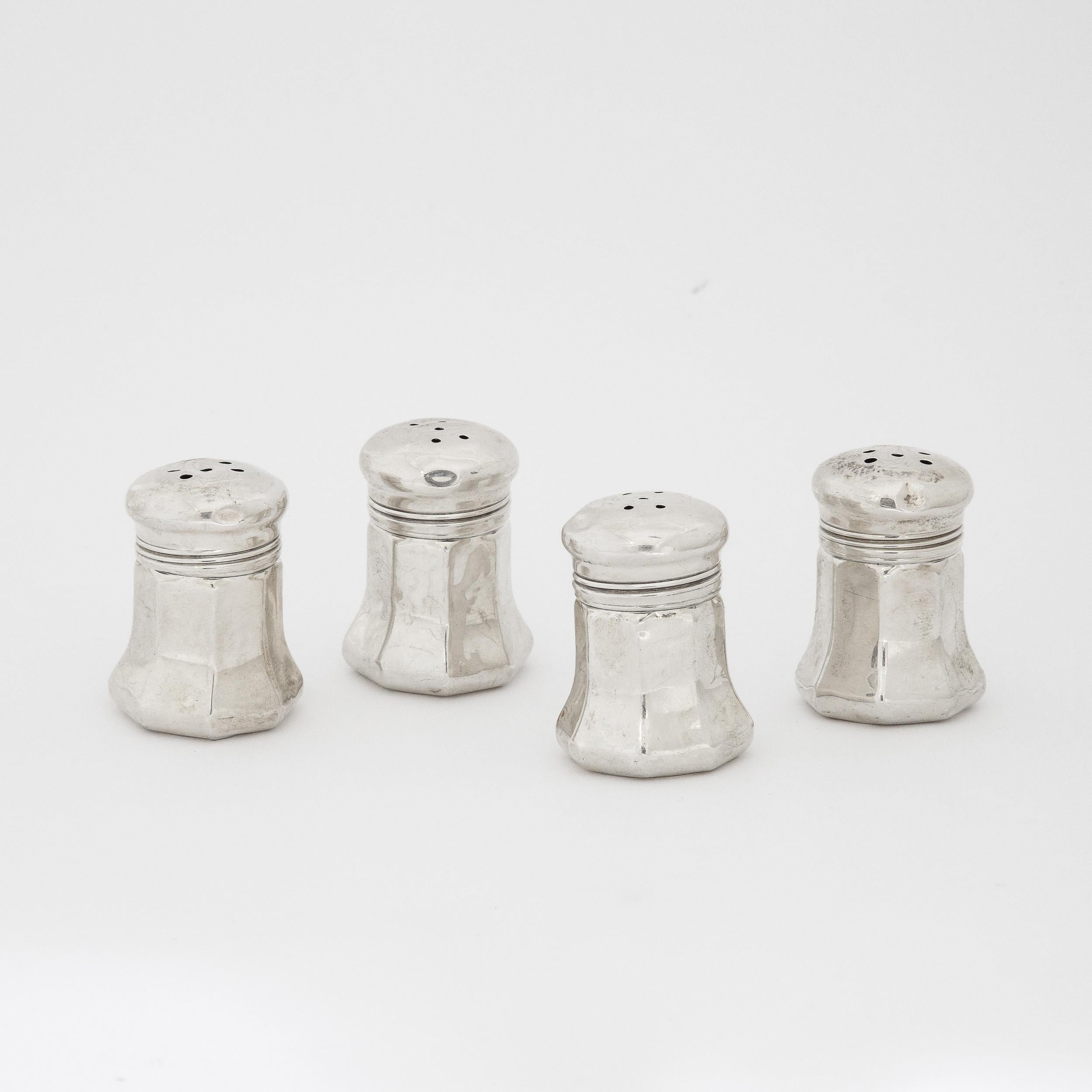 These charming Cartier Sterling Silver Salt Shakers originate from France during the 20th Century. Beautifully formed in sterling silver with signatures on the undersurface and the classic Cartier motif detailed on the top along with pierced