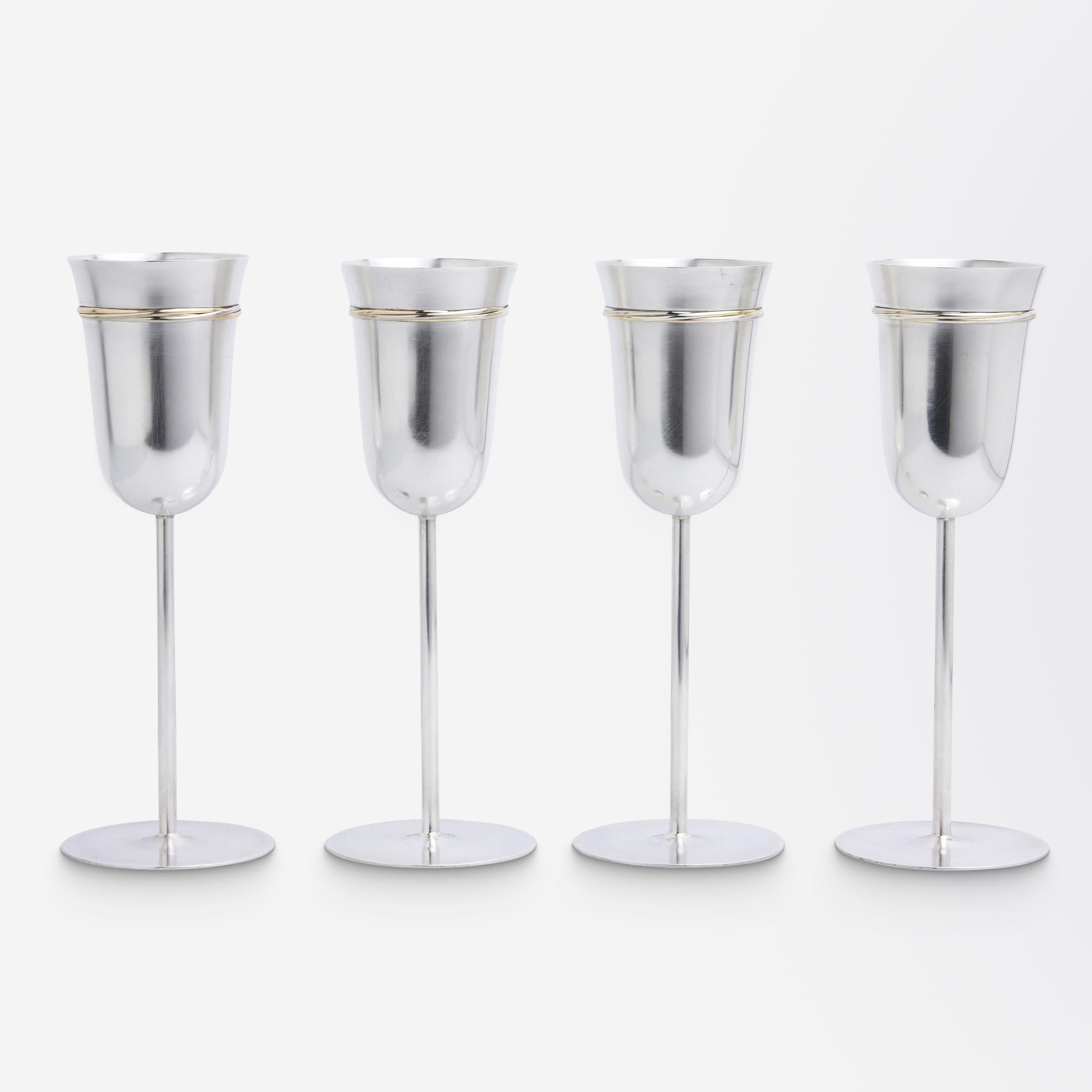 Questo set di quattro flûte da champagne in argento sterling è stato realizzato per la vendita al dettaglio da Cartier nella seconda metà del XX secolo. La parure, realizzata in argento massiccio, presenta sulla parte superiore di ogni flauto una