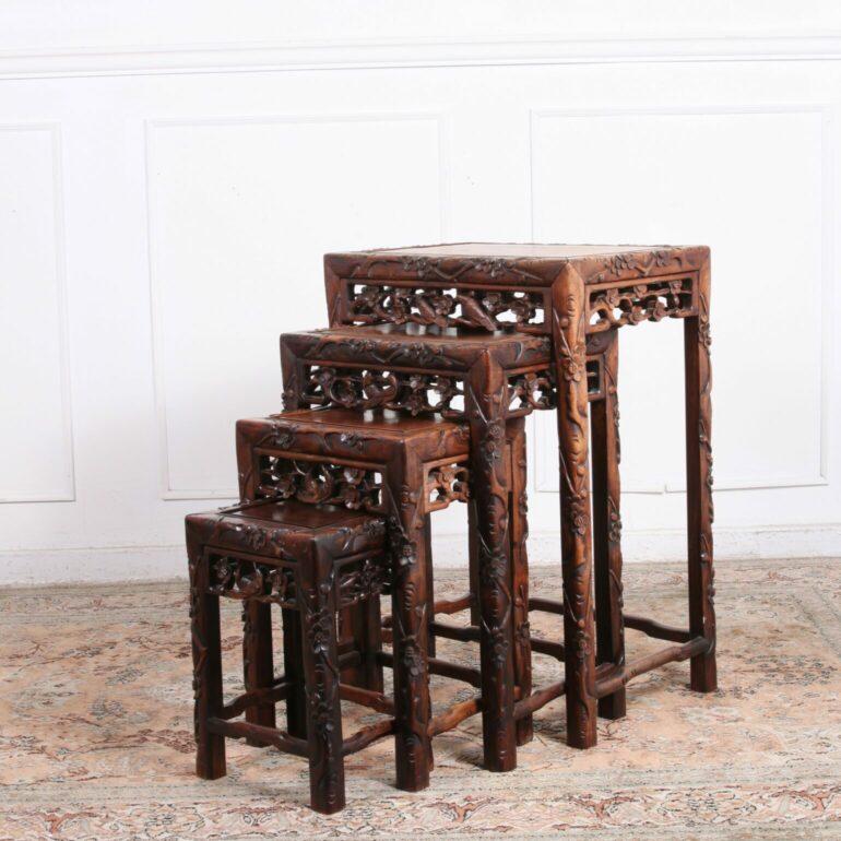 Set of Four Carved Rosewood Chinese Nesting Tables. Very solid and excellent quality. Hand carved, hump back stretches (at bottom of the legs) grape and vine design, Victorian era.