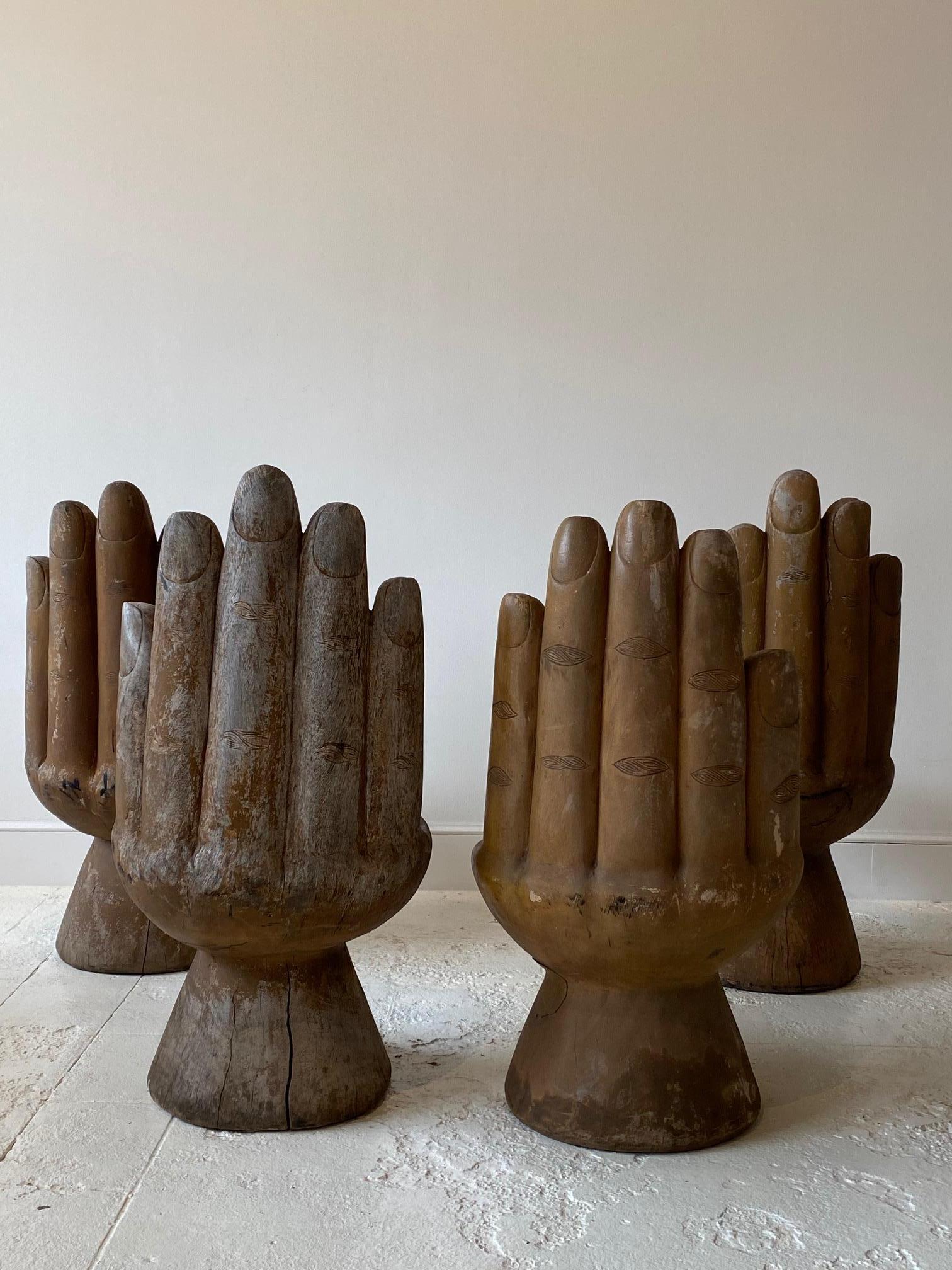 Set of four wooden hand chairs in the style of style of Pedro Friedeberg. A unique, hand carved wood chair in the shape of a cupped hand.