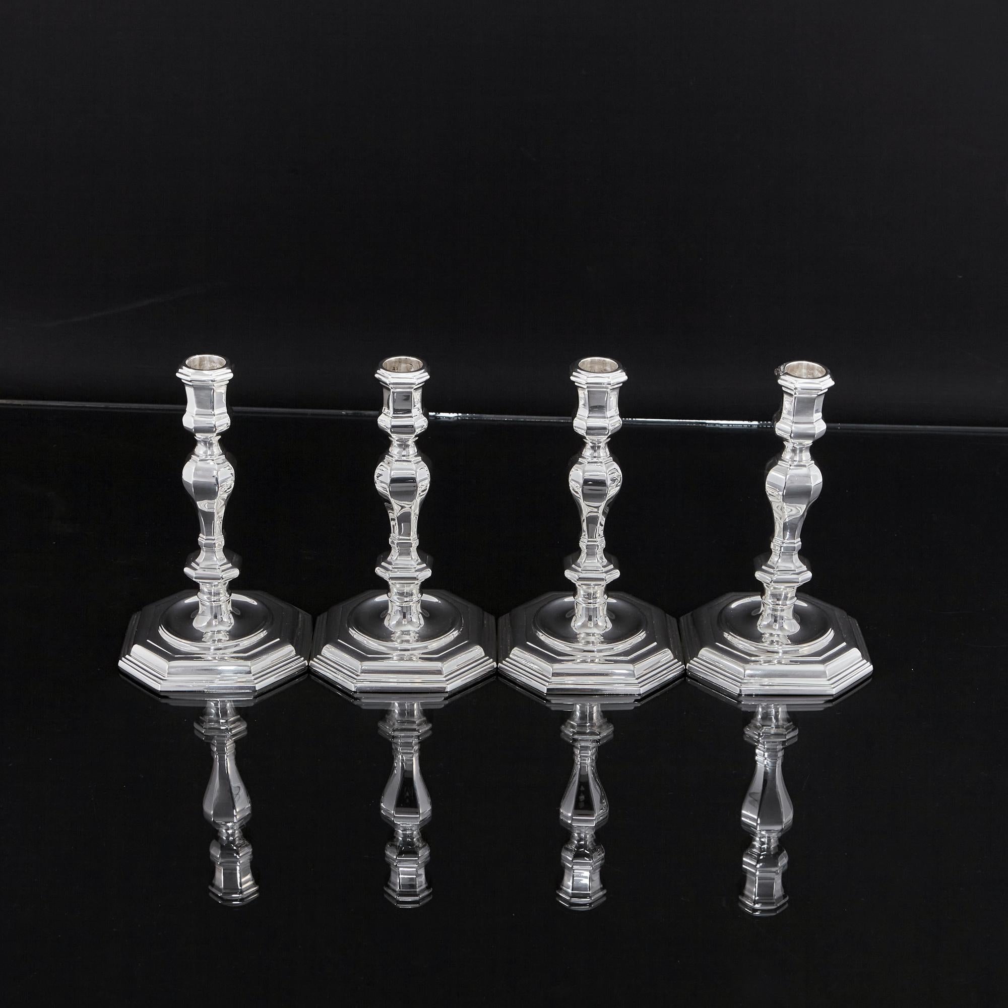 Set of four cast silver candlesticks in the style that would have been popular in the early 18th century, during George I's reign. This set of silver candlesticks is particularly well finished and of substantial weight. Design features include the