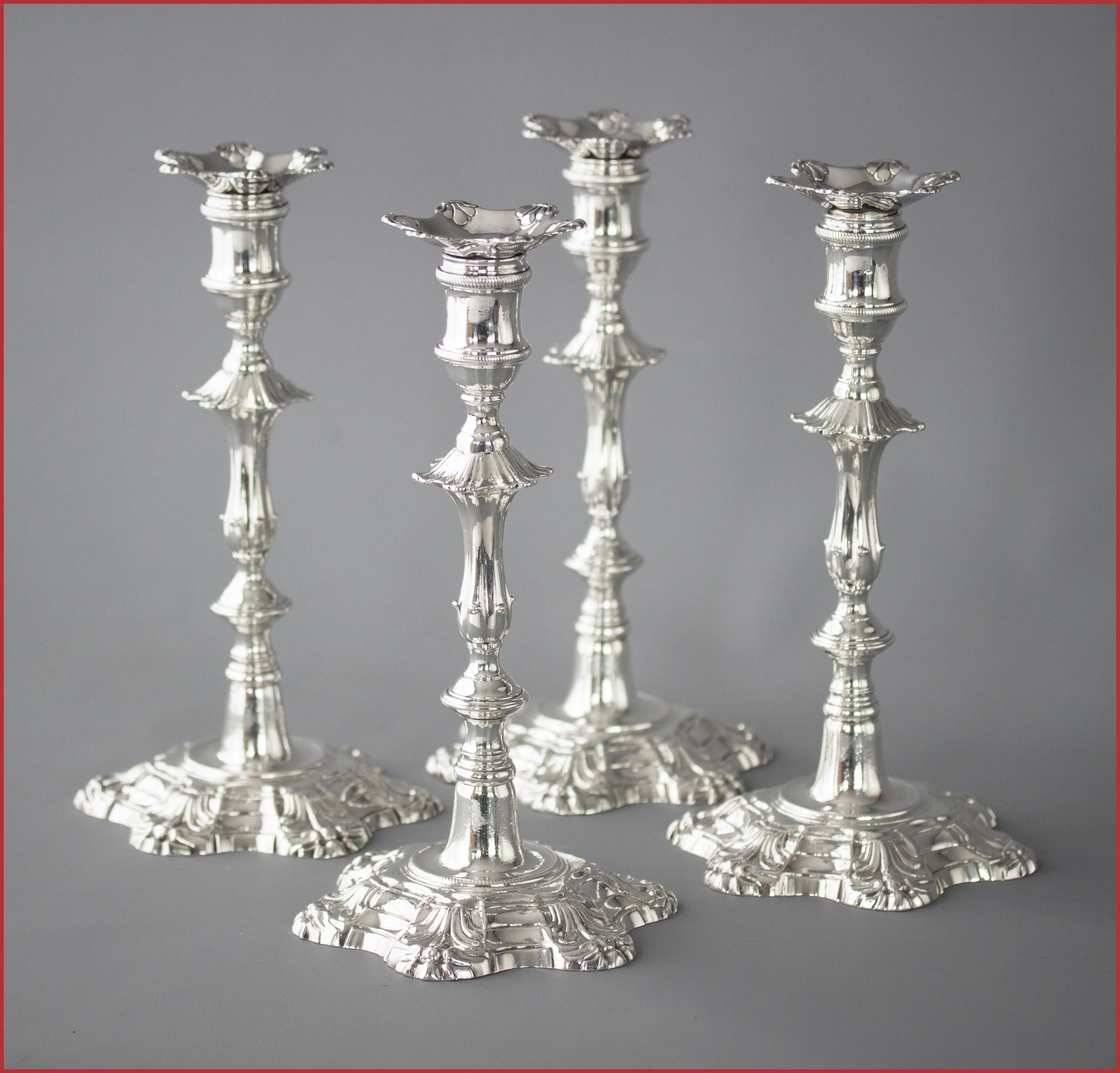 An extremely fine set of cast Silver candlesticks of petal form decoration rising from a stepped, circular, rope twist decorated base to a tapered fluted column beneath a hexagonal knop. The capitals of cotton reel form with rope twist decoration.
