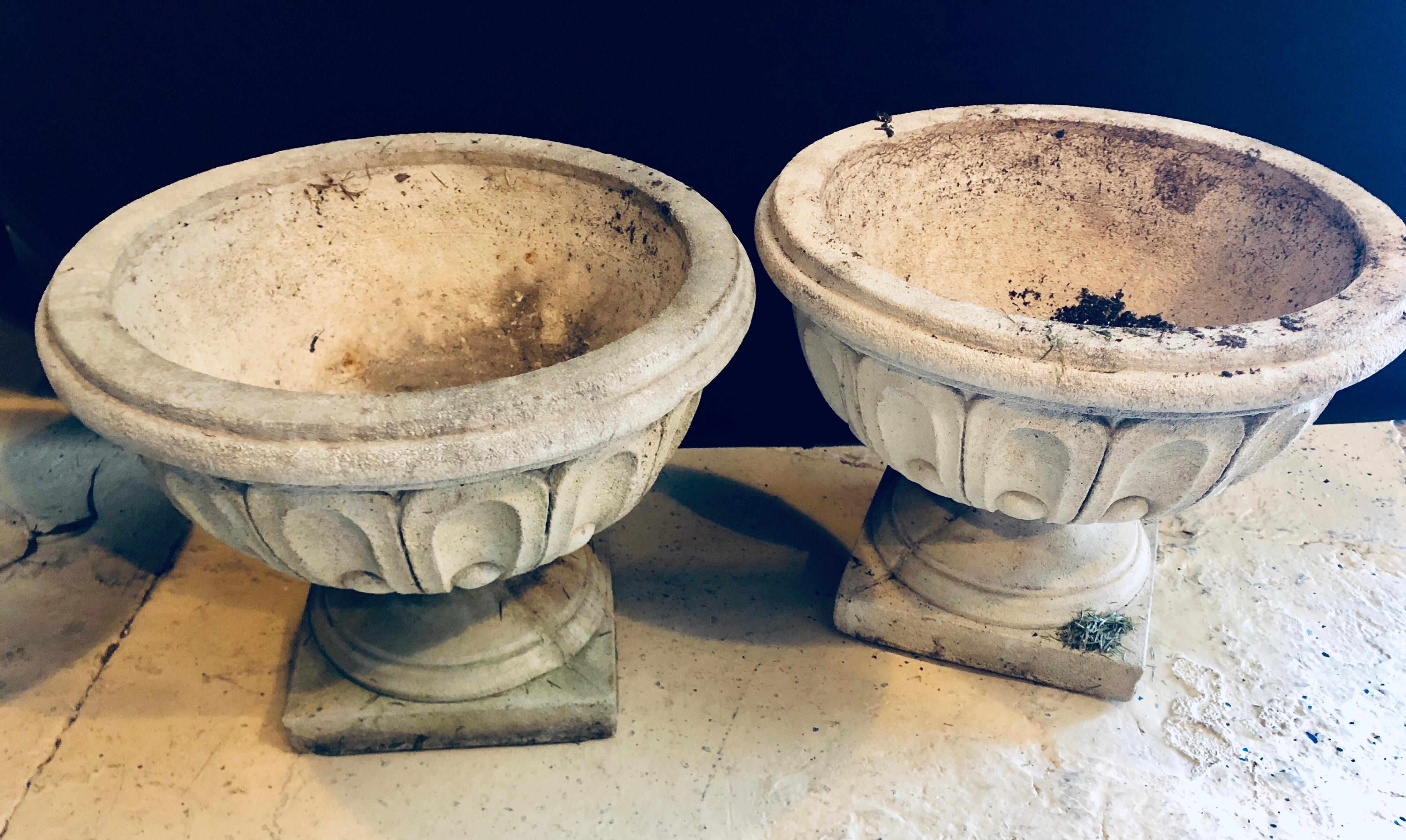 Set of four cast stone urns or flower pots. Each of these nicely detailed urns come directly from a Greenwich CT mansion. One with a chip on the corner as photographed.