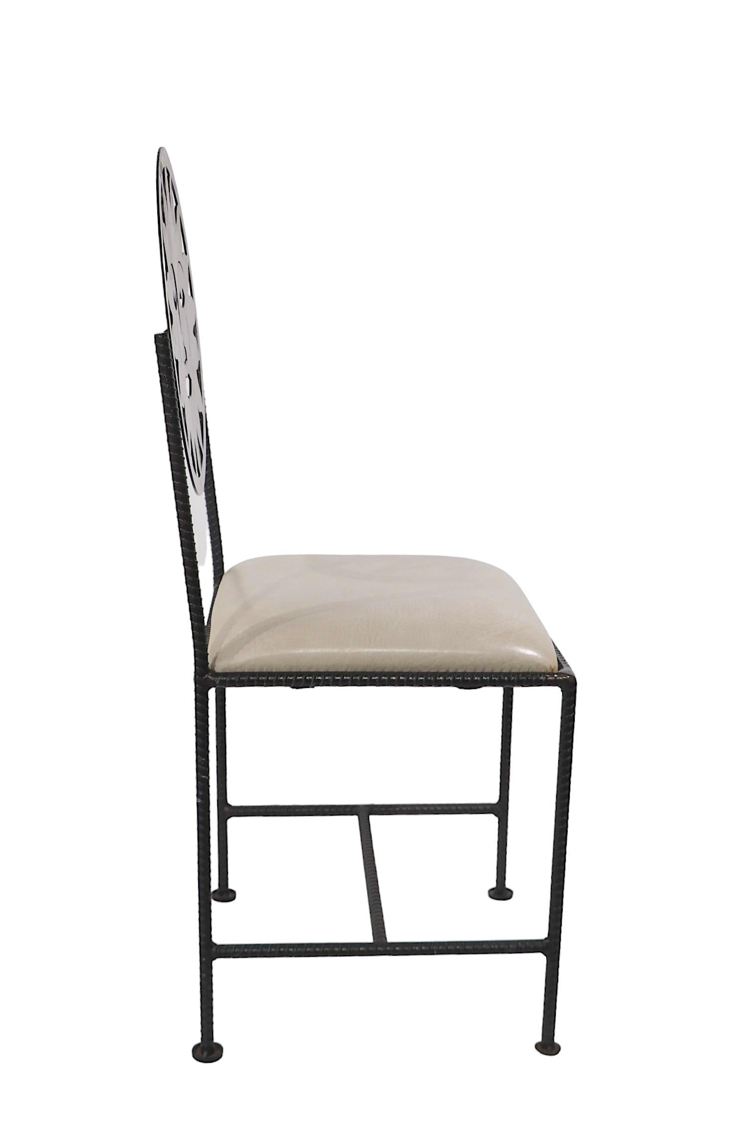 Decorative set of four sun motif  metal and naugahyde dining chairs, made in Mexico circa 1990's. The chairs feature a stylized sun faces as back rests, and rebar frames. All are structurally sound and sturdy, one seat shows a tear in the vinyl pad