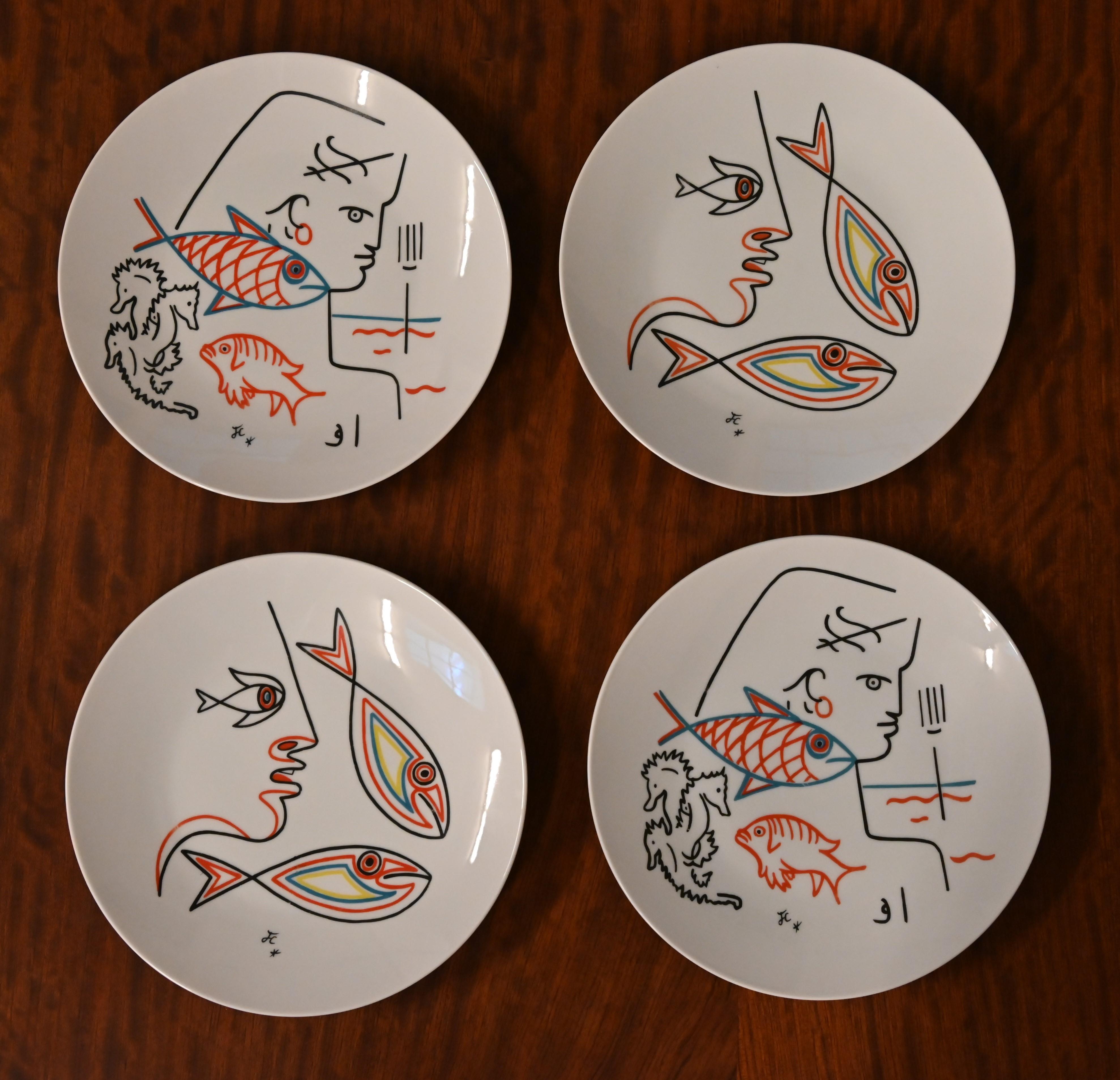 Four ceramic plates signed 