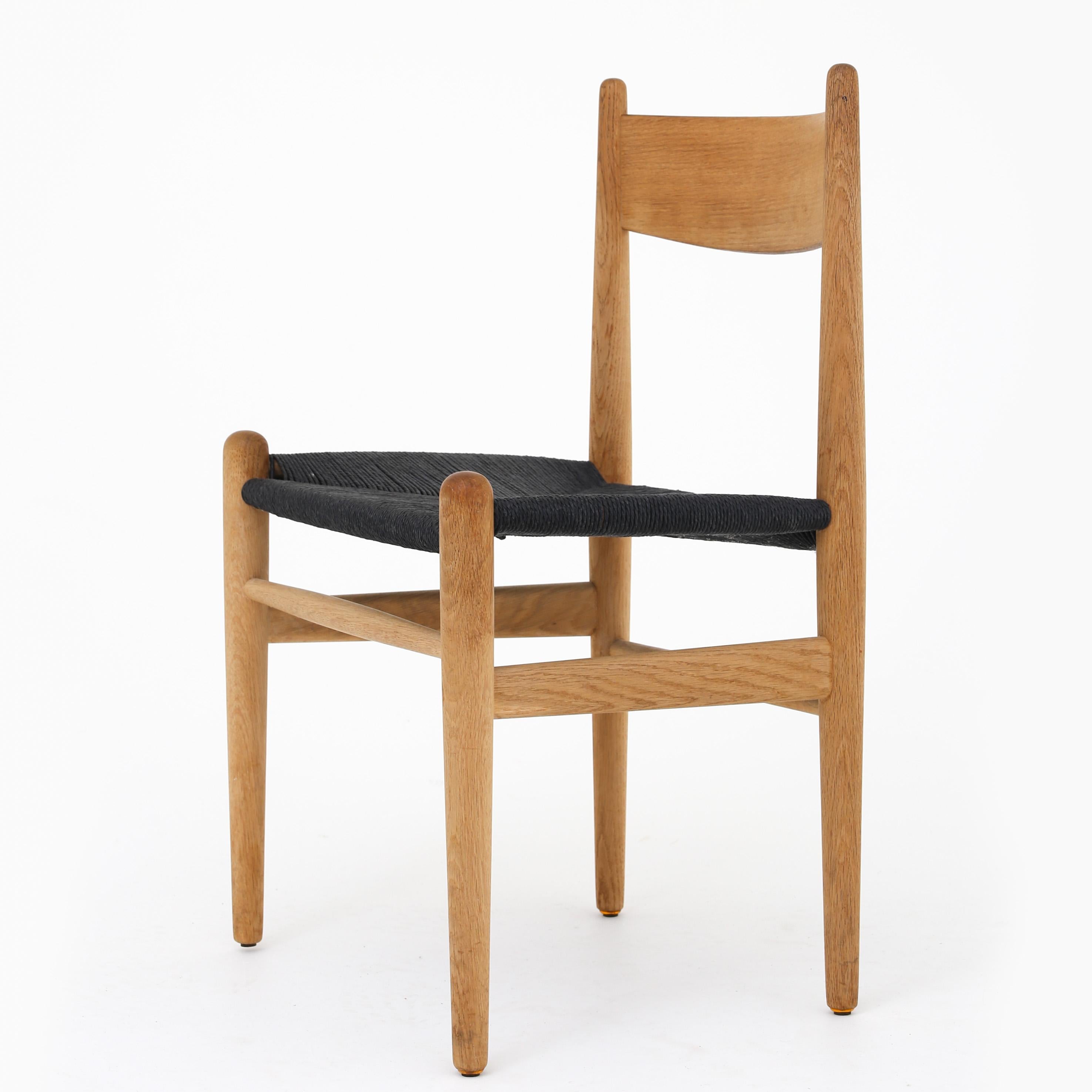 Hans J. Wegner / Carl Hansen & Son. CH 36 - set of 4 dining chairs in solid oak and black paper yarn. Designed in 1962.