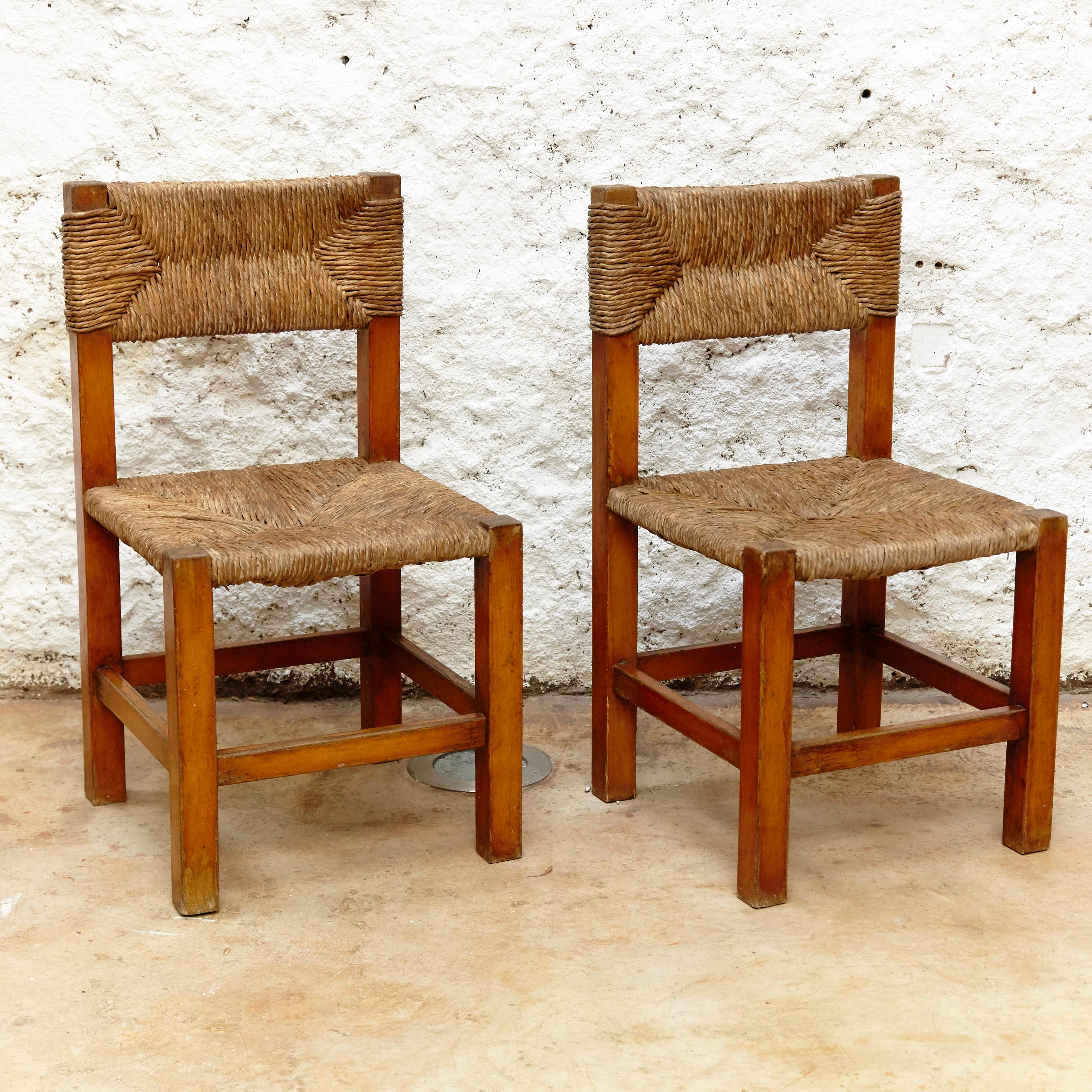 Mid-Century Modern Set of Four Chairs after Charlotte Perriand in Wood and Rattan, circa 1950