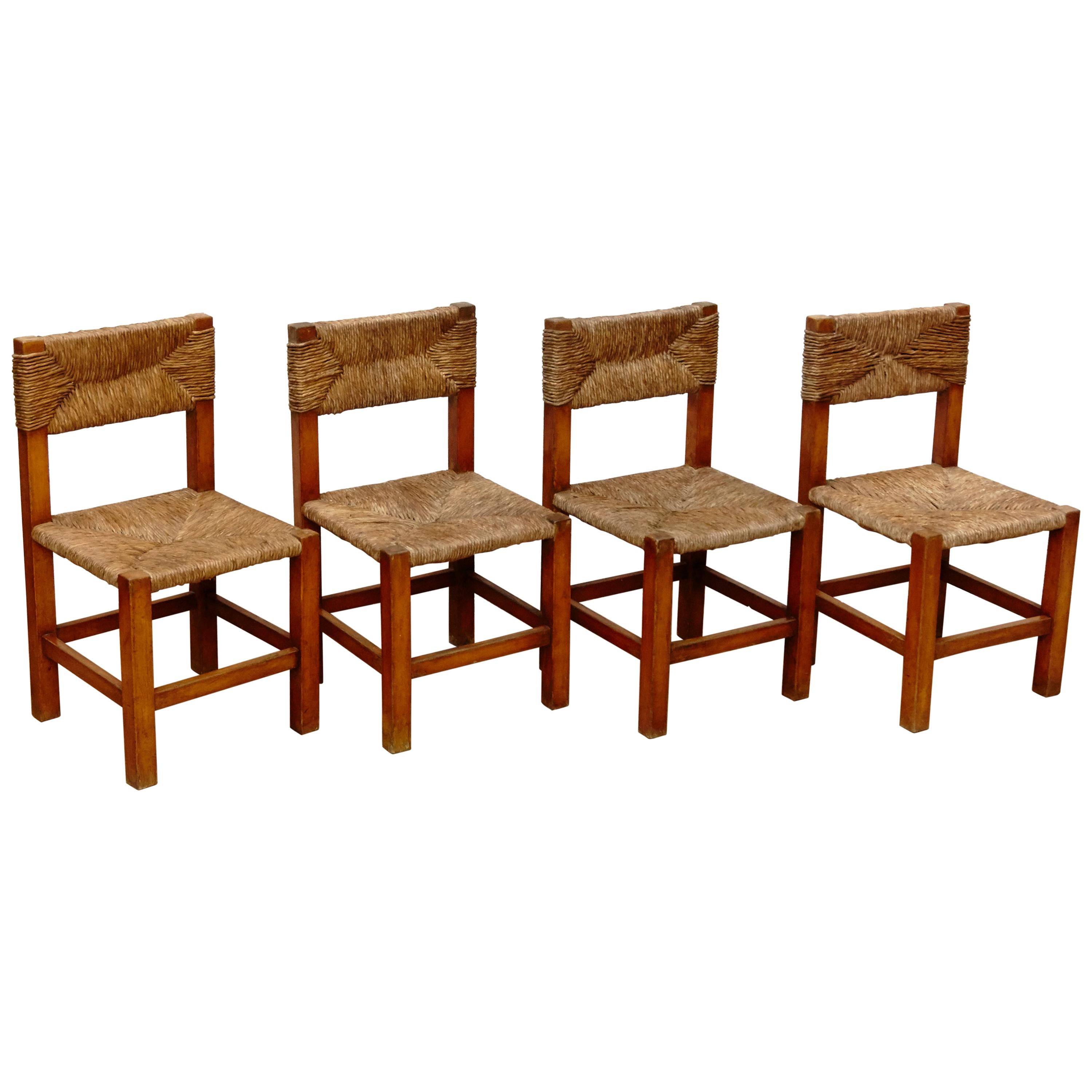 Set of Four Chairs after Charlotte Perriand in Wood and Rattan, circa 1950