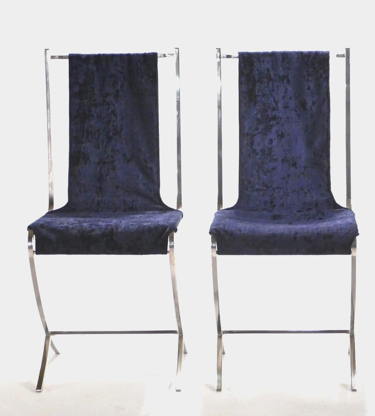 Lounge on extravagant deep blue velvet, suspended across a sturdy, but artfully imagined structure made of heavy nickeled metal. This set of 4 chairs was created by French Avant Garde designer Pierre Cardin for well-known interior design firm Maison