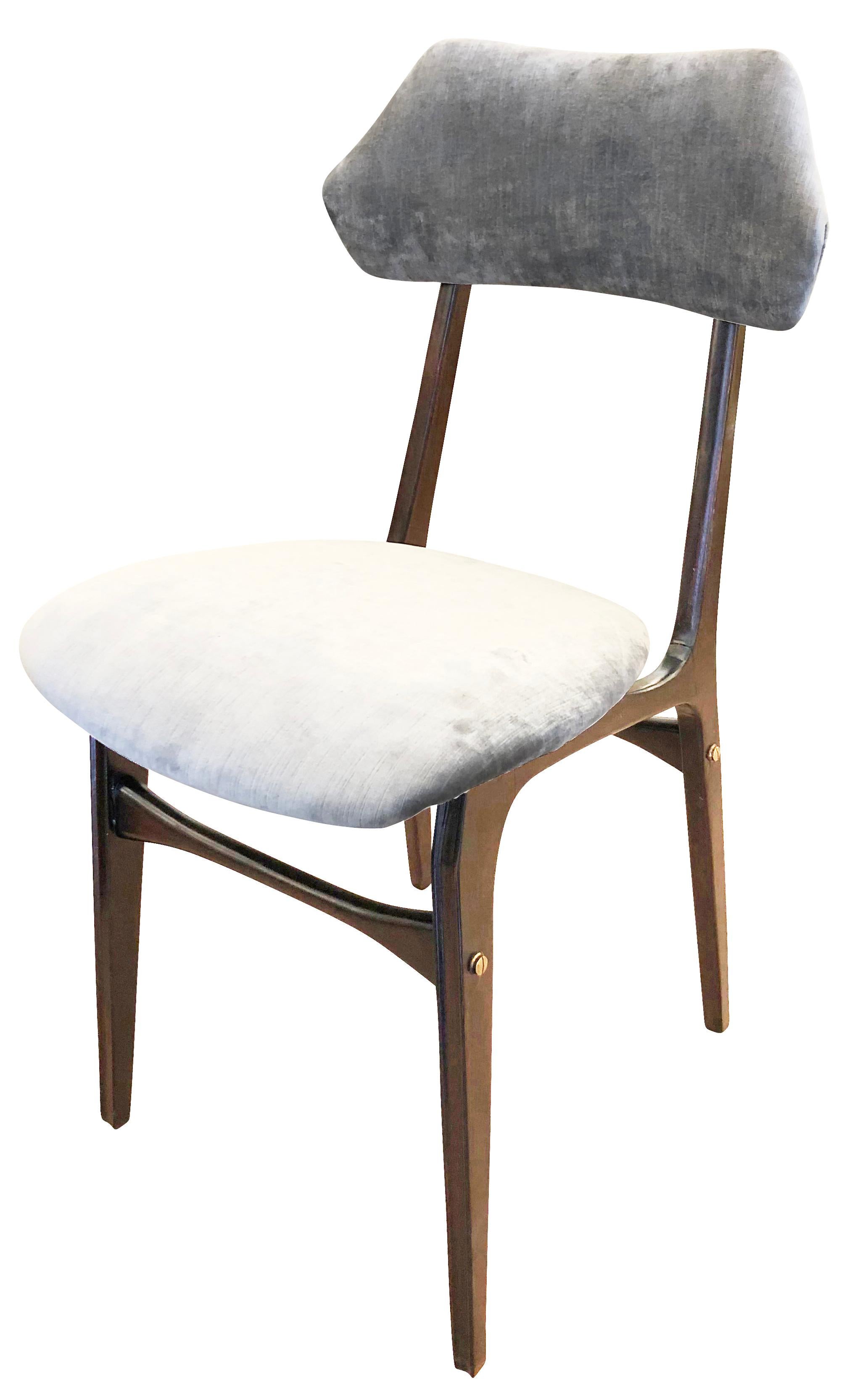Set of four Italian midcentury chairs in the manner of Ico Parisi with sculptural wood frames.

Condition: Frames have been restored. One has been re-covered for display purposes and the others still have the original fabric

Measures: Width