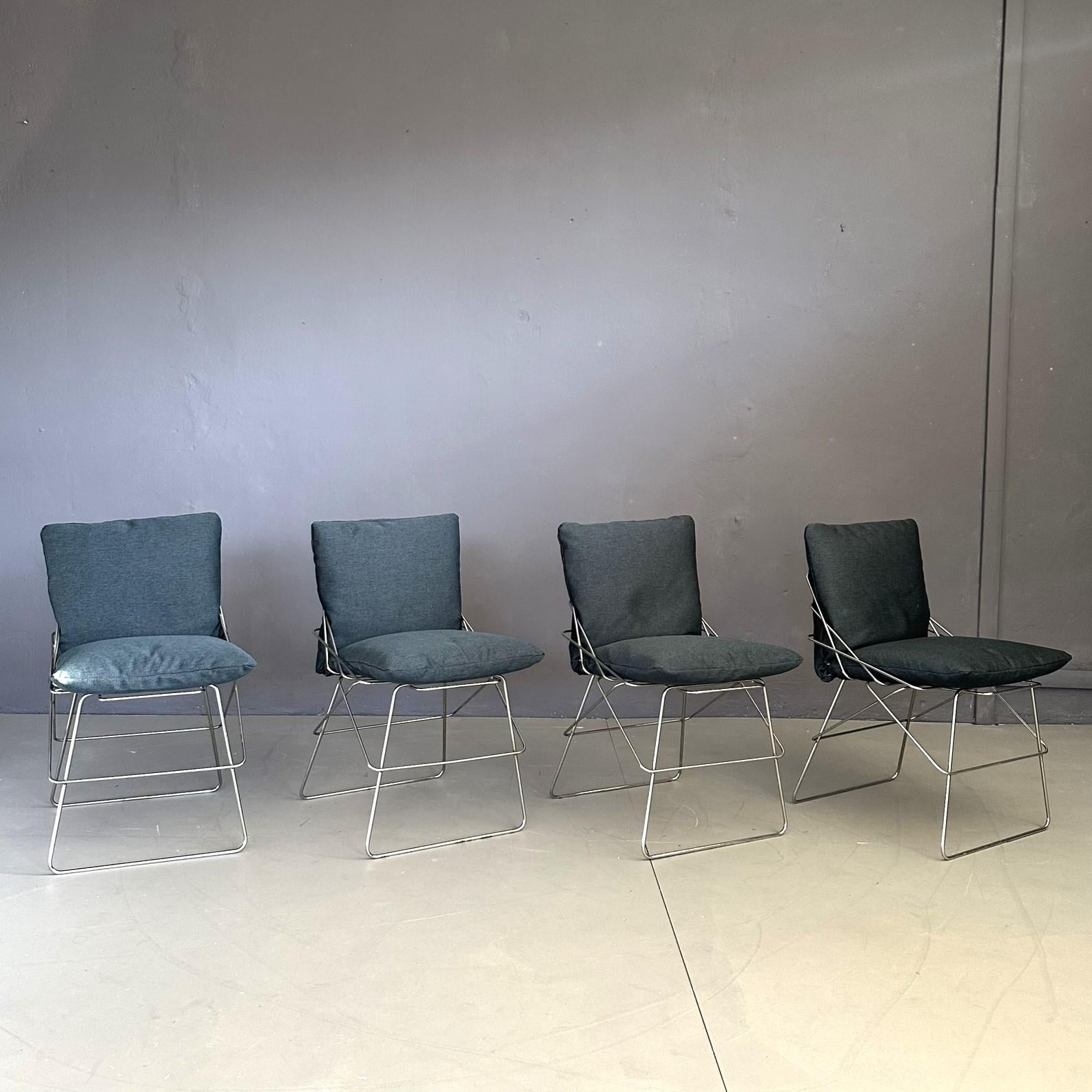 
Set of four chairs model SOF SOF design by Enzo Mari, for Daride 70s. Chromed metal rod structure, with seat and backrest upholstered in blue fabric.
Seat that summarizes the essentiality and elegance of Enzo Mari's design. Created by Driade in