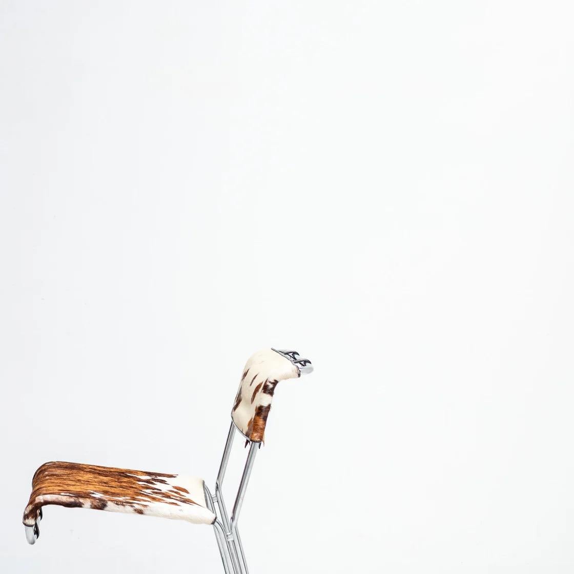 Featuring cantilevered chrome frames with unique upholstery, each chair combines sculptural lines with interesting natural variations. Comfortable in proportion yet visually light, these chairs capture the spirit of Italian design in the postmodern