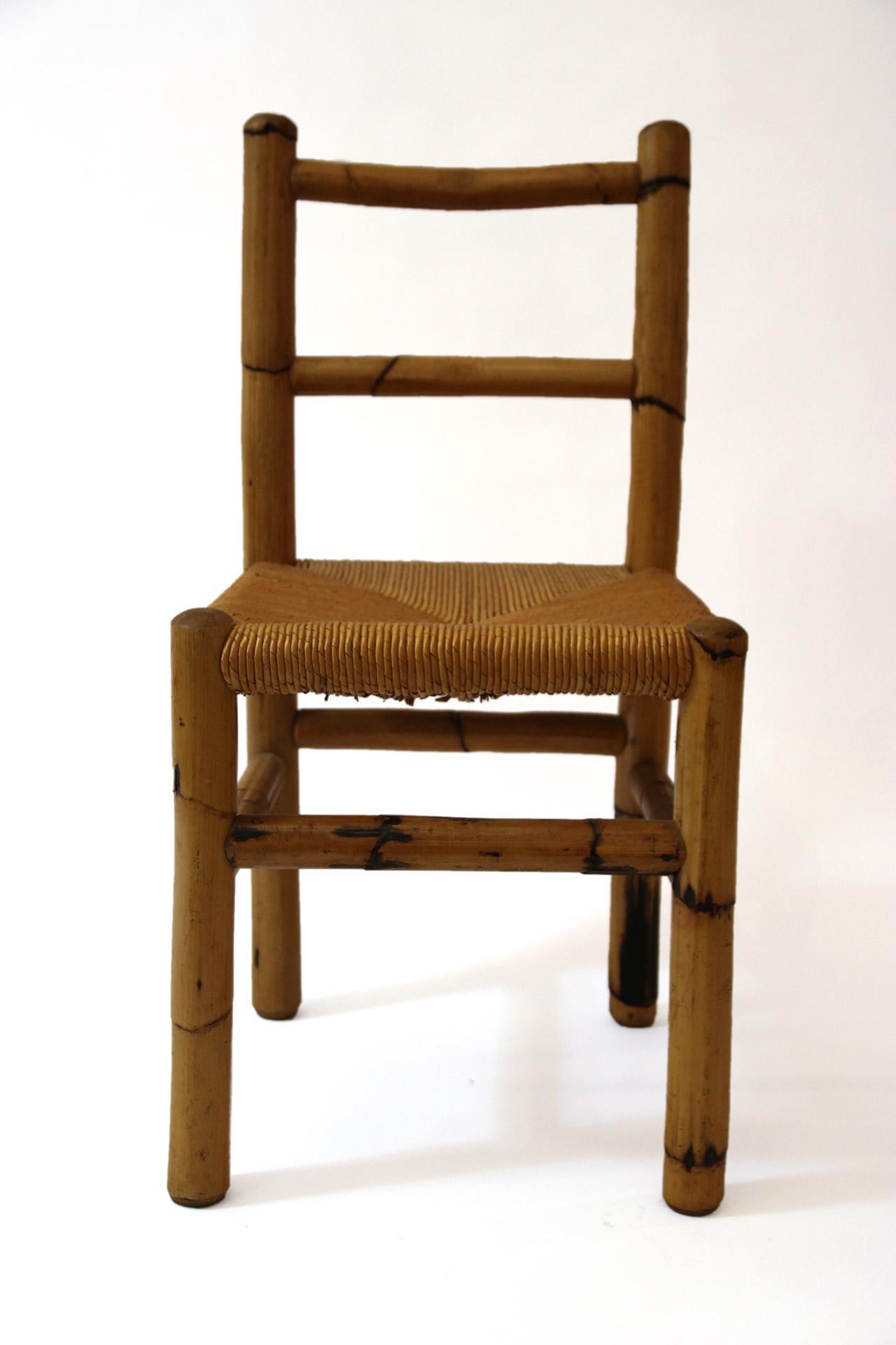 Set of four chairs, 
wood and bamboo, 
circa 1970, France.
Measures: Height 85 cm, seat height 46 cm, width 41 cm, depth 40 cm.