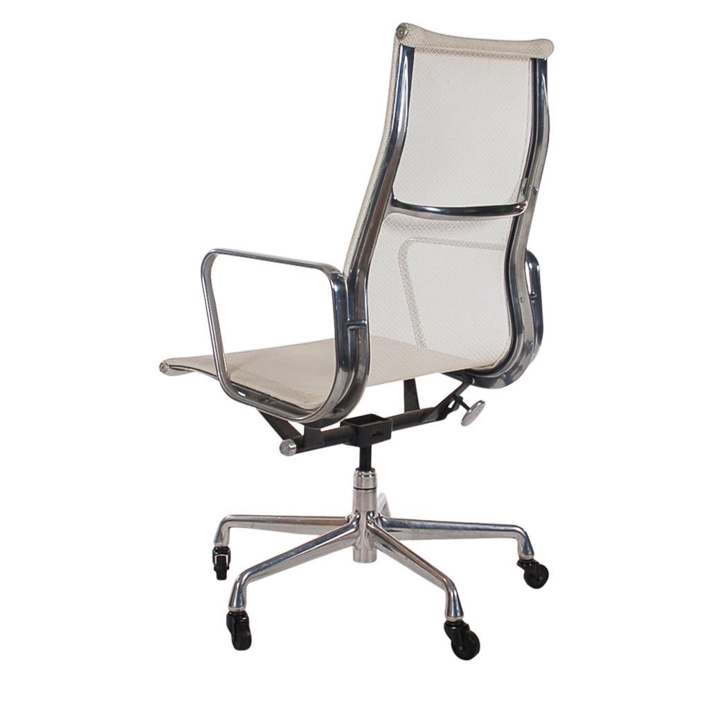 Complete set of 4 modern conference chairs or office chairs by Charles Eames and produced by Herman Miller. These chairs features an adjustable aluminum frame, casters for easy tasking, and a white mesh sling seating area. Extremely comfortable.