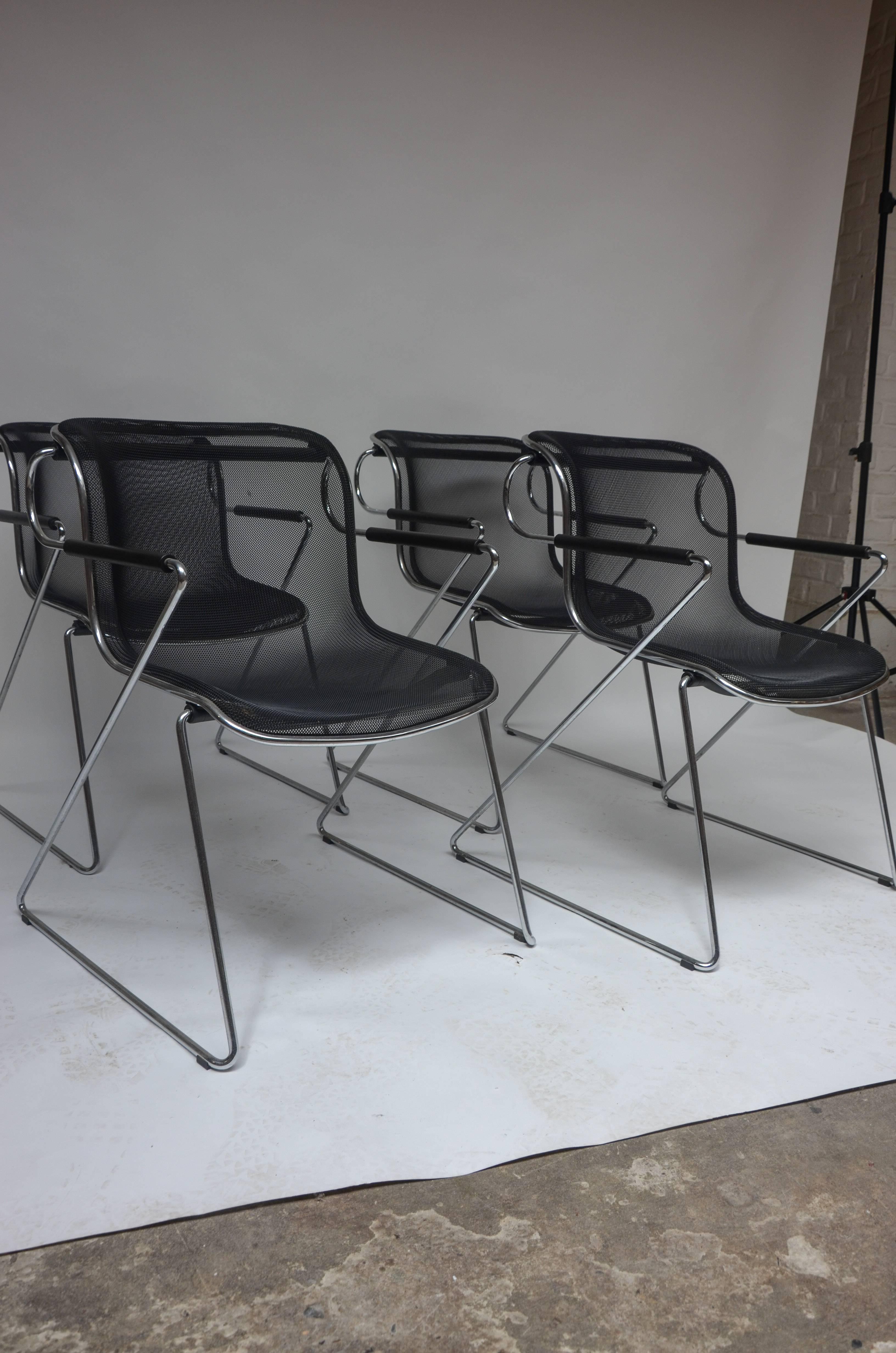 Set of four Penelope chairs designed by Charles Pollock for Castelli (1982). Constructed of chrome arms and legs with a steel wire sled seat sitting on a polyurethane shock absorbing tube, this design Classic is comfortable, has a beautiful