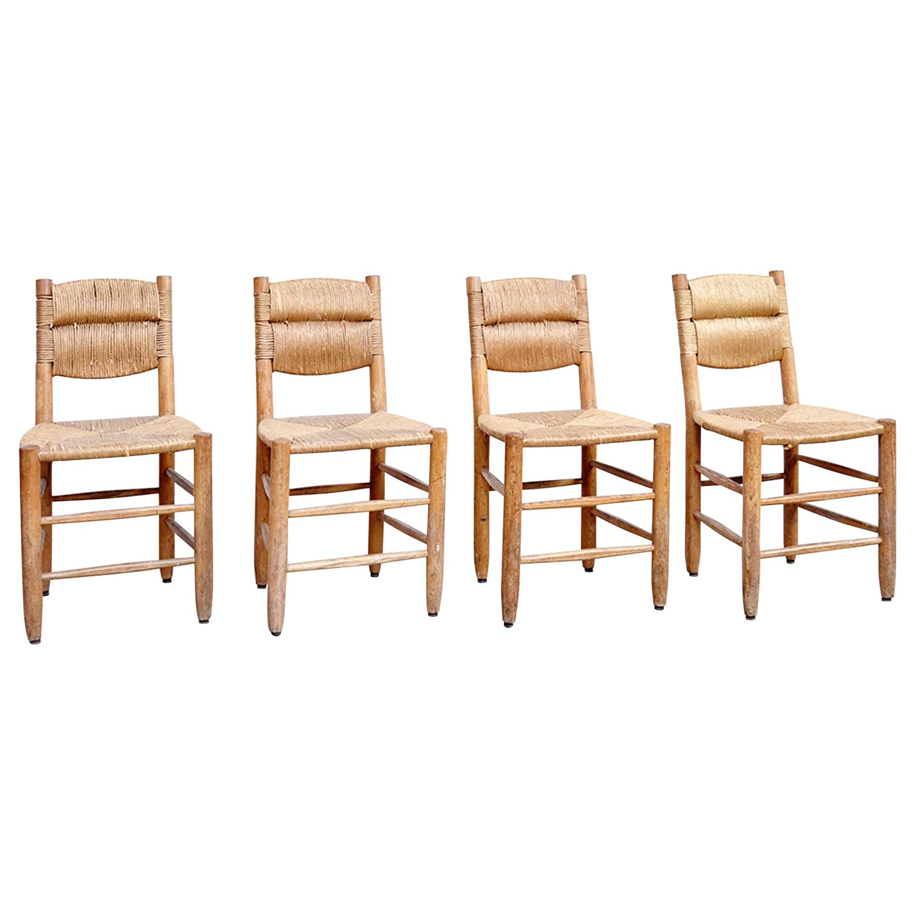 Set of four chairs designed by Charlotte Perriand, circa 1950.
Manufactured in France.

In good original condition, with minor wear consistent with age and use, preserving a beautiful patina. 

Charlotte Perriand (1903-1999) she was born in