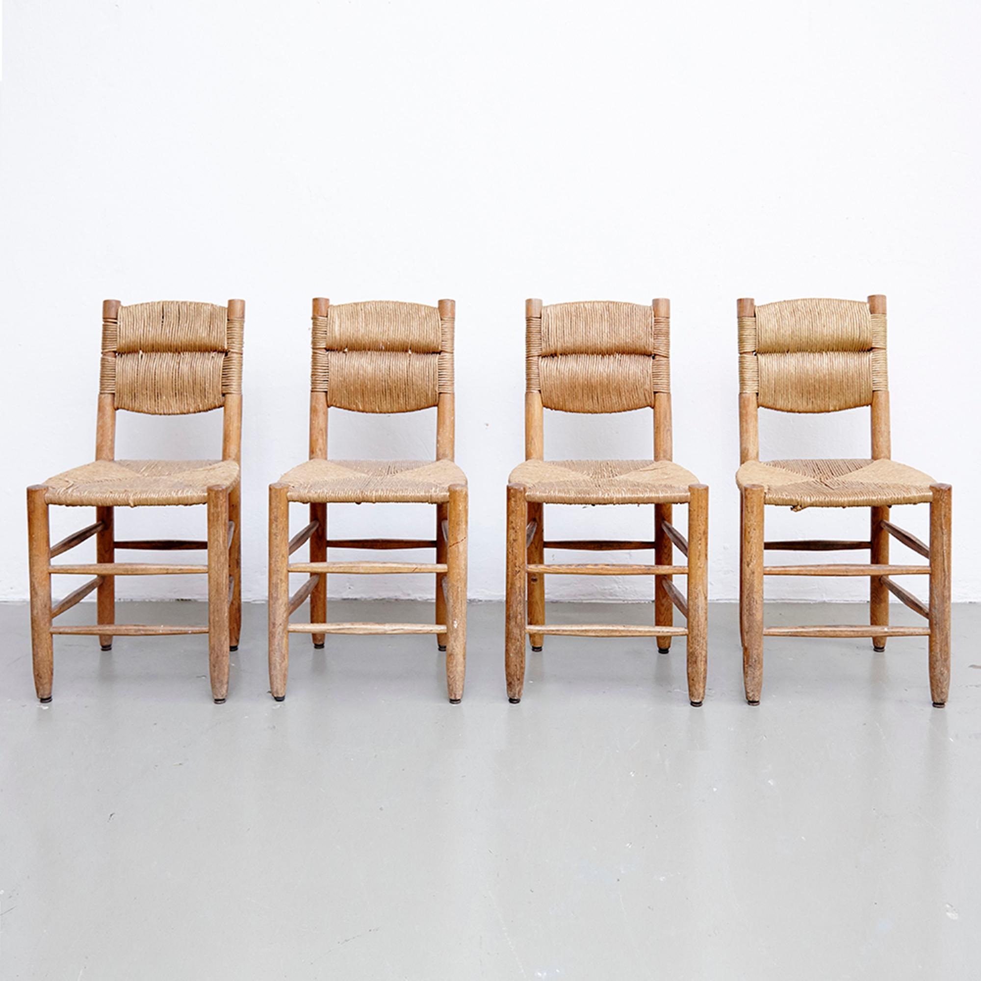 Set of four chairs designed by Charlotte Perriand, circa 1950.
Manufactured in France.

In good original condition, with minor wear consistent with age and use, preserving a beautiful patina. 

Charlotte Perriand (1903-1999) she was born in