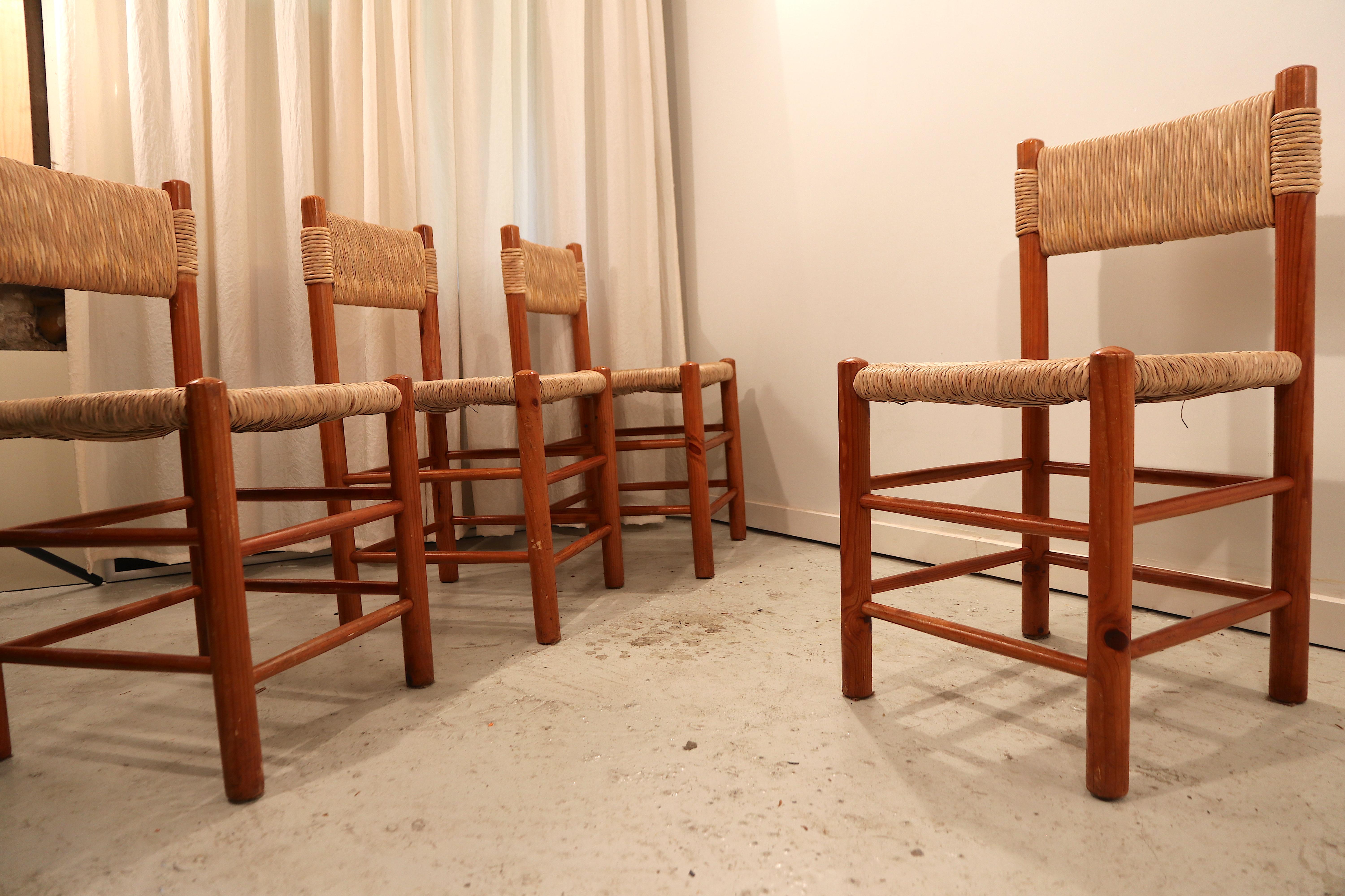 Wonderful set of 4 dining chairs by Charlotte Perriand, model Dordogne for Sentou. Pine wood structure in a wonderful condition and straw seat and back rest, in excellent condition as well. Another set of 4 is available, please ask in case