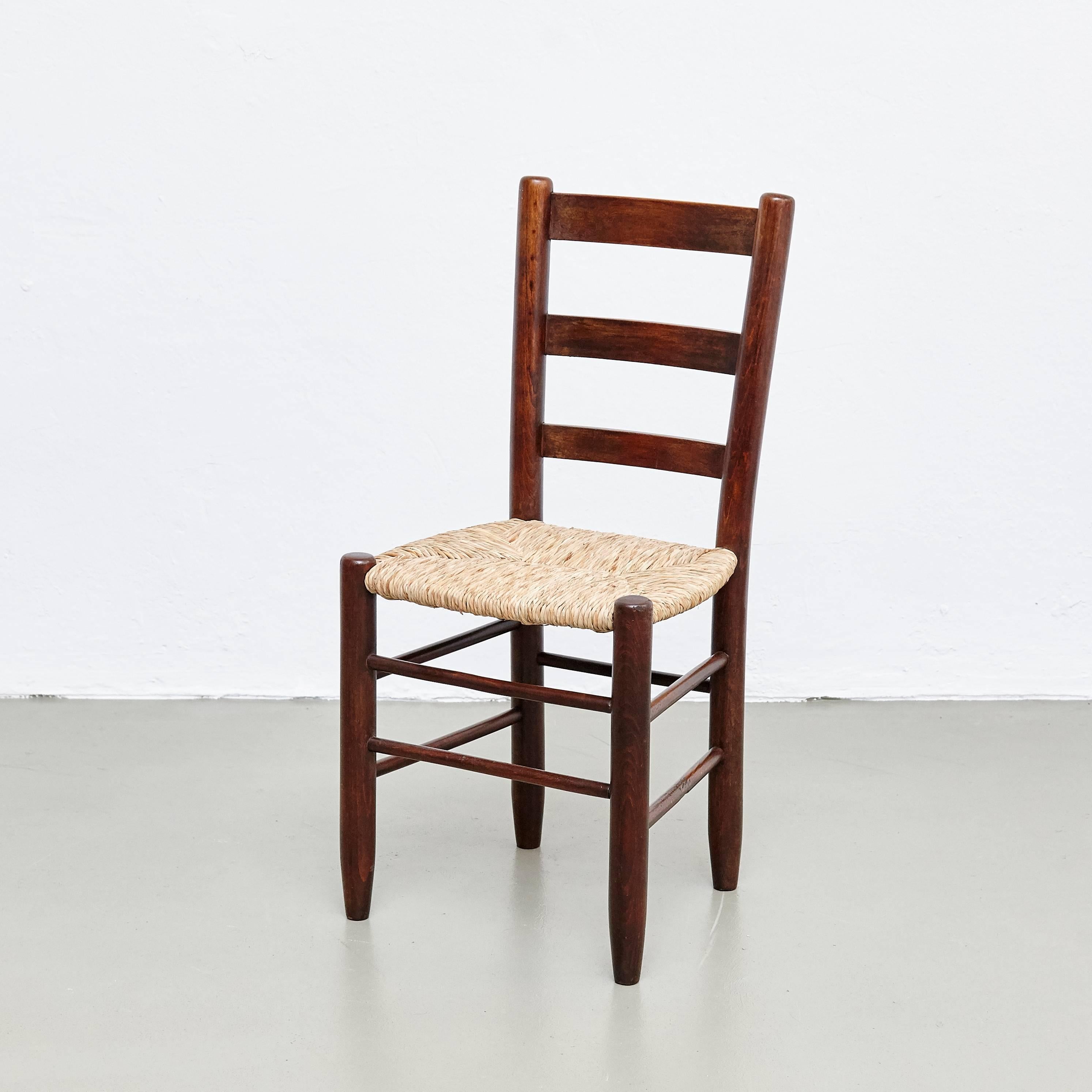 Set of four dining chairs, model Meribel, designed by Charlotte Perriand, circa 1950.

Solid wood base and legs, and rush seat.

In good original condition, with minor wear consistent with age and use, preserving a beautiful patina. The seats