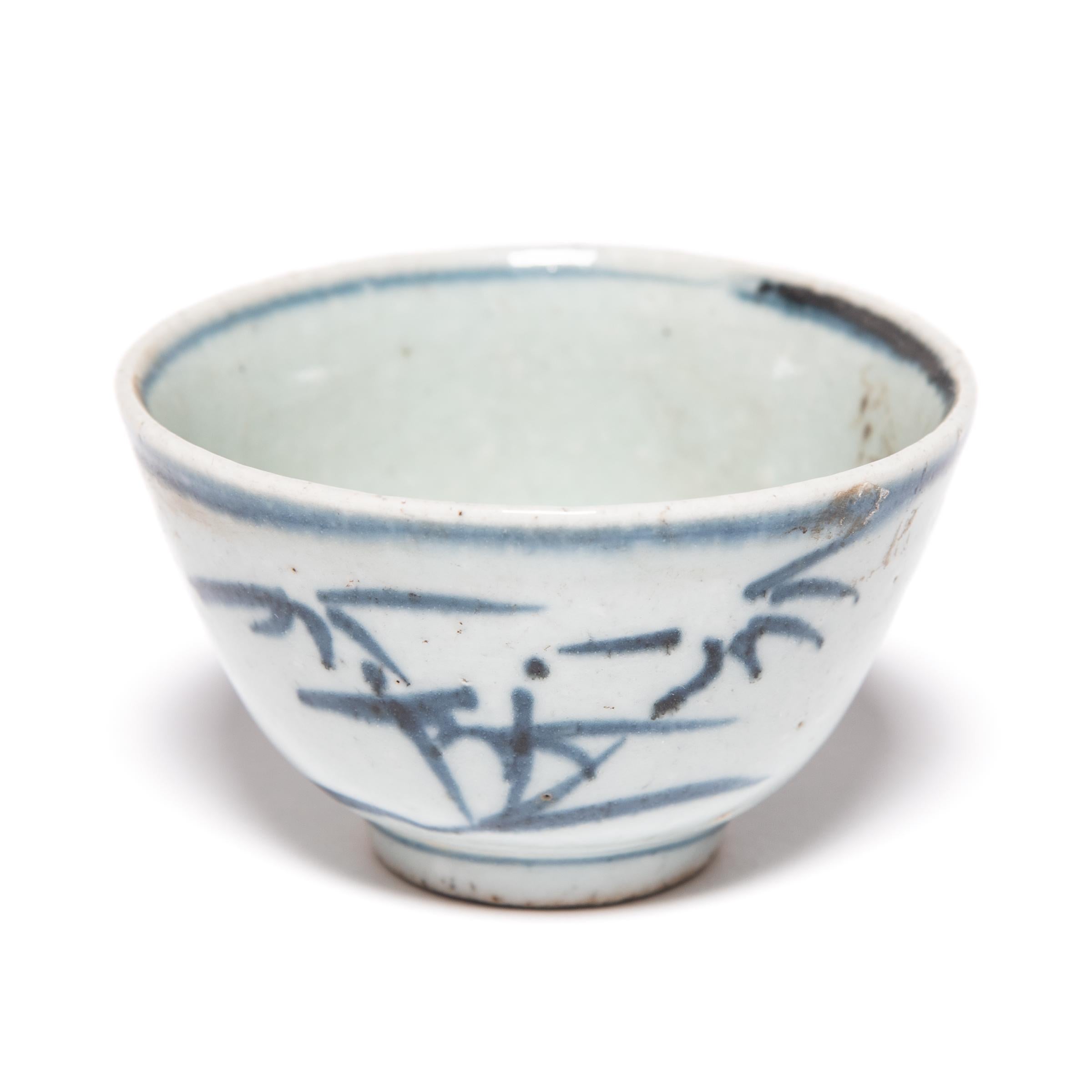 The delicate blue and white bamboo design of these porcelain teacups was painted in a muted, grey pigment, only to be transformed to a rich, cobalt blue by the fiery heat of the kiln. Retaining the immediacy of the artist’s brushwork, the design