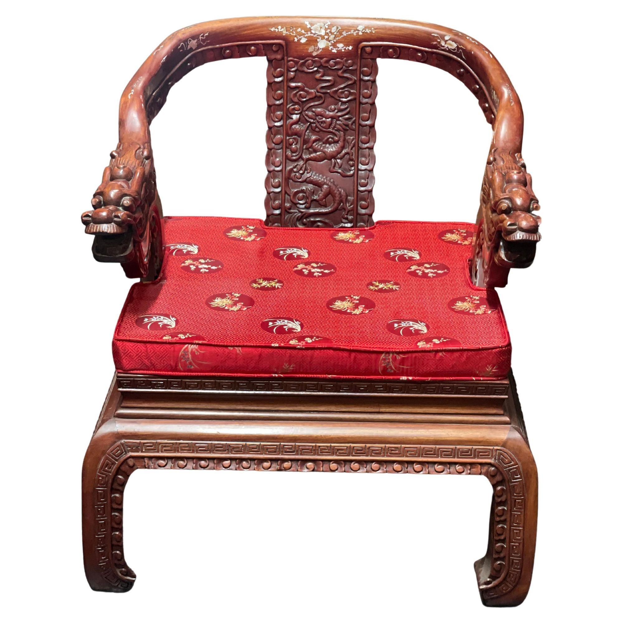 Set of four Chinese carved wood arm chairs depicting dragon figures all around, mother of pearl inlay and red satin cushions with floral patterns. (circa 1950s)
Dimensions:
30