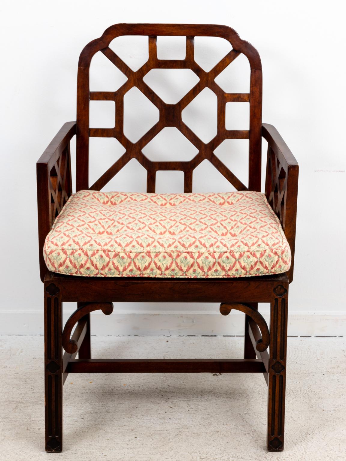 Set of four upholstered Chinese Chippendale style chairs with h-shaped cross stretchers and geometric Chinese Chippendale style tracery on the seat back. Please note of wear consistent with age including minor finish loss. The listed measurements