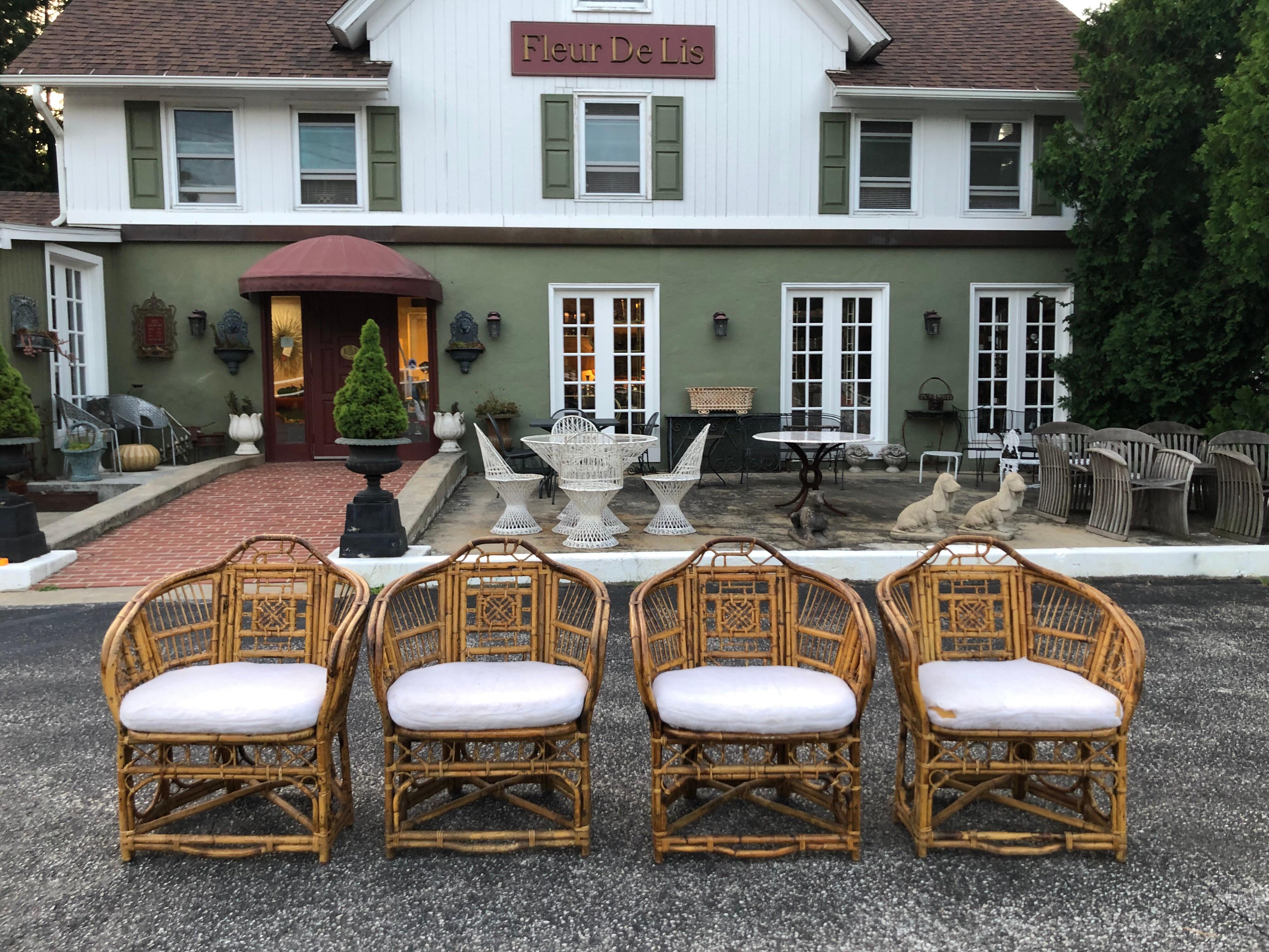 Set of four Chinese Chippendale bamboo chairs with cushion pads. Airy tropical island look. Perfect for an indoor porch sun room or breakfast nook. Custom pads need to be recovered. Seat depth is 18.50