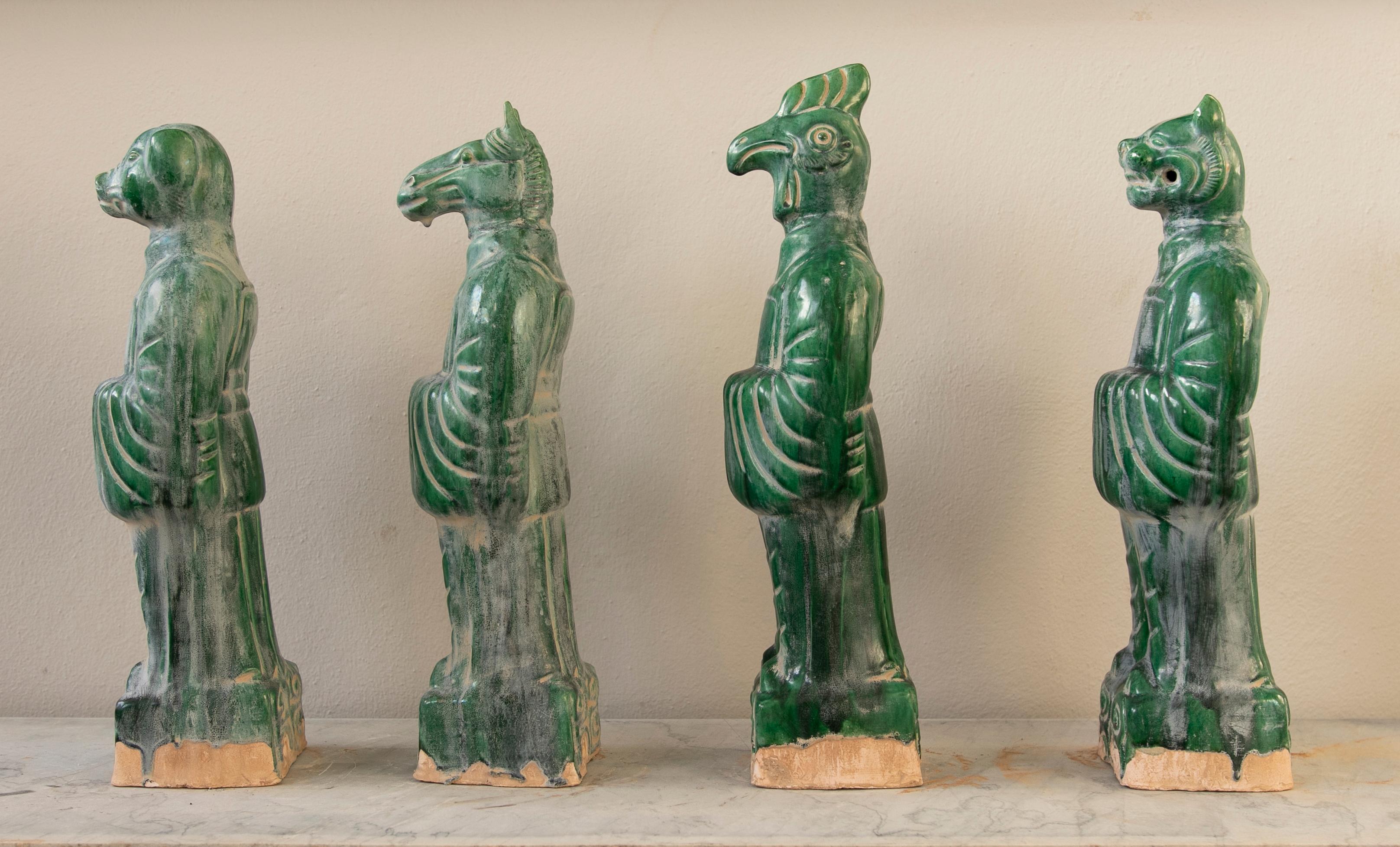 Set of four Chinese Mythological gods in green glazed Terracotta.